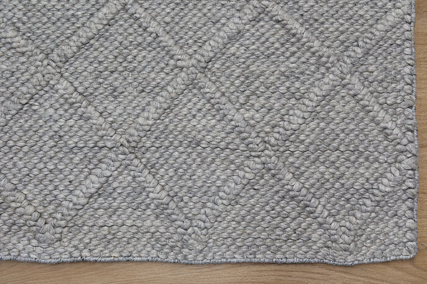 Lounge Aluminium is a luxurious wool and bamboo silk rug, featuring a modern Scandinavian Diamond Pattern design and textured hand loomed pile. With pile height of 16-18mm. Colour Aluminium Grey. Sizes 160 X 230, 200 X 290 and 240 X 340. Corner.