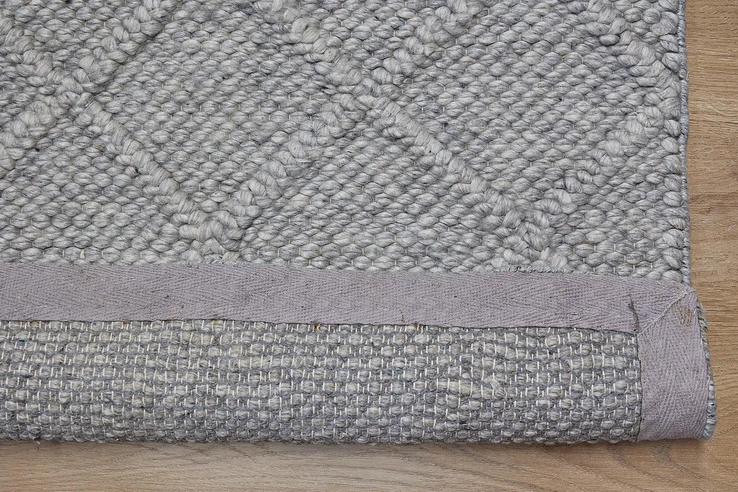 Lounge Aluminium is a luxurious wool and bamboo silk rug, featuring a modern Scandinavian Diamond Pattern design and textured hand loomed pile. With pile height of 16-18mm. Colour Aluminium Grey. Sizes 160 X 230, 200 X 290 and 240 X 340. Fold.