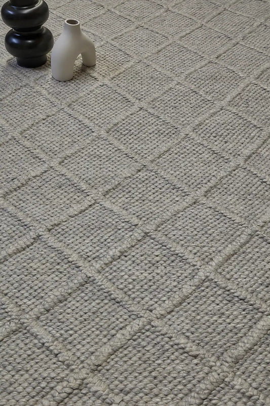 Lounge Aluminium is a luxurious wool and bamboo silk rug, featuring a modern Scandinavian Diamond Pattern design and textured hand loomed pile. With pile height of 16-18mm. Colour Aluminium Grey. Sizes 160 X 230, 200 X 290 and 240 X 340. Life.