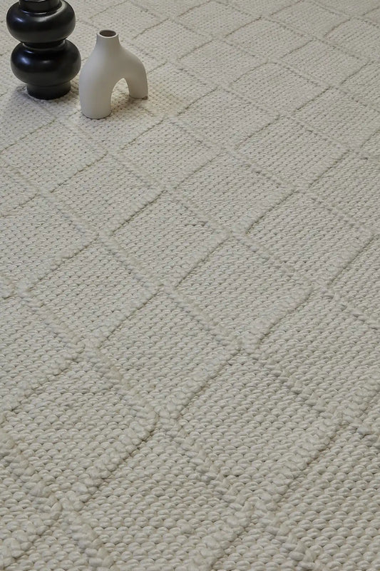 Lounge White is a luxurious wool and bamboo silk rug, featuring a modern Scandinavian Diamond Pattern design and textured hand loomed pile. With pile height of 16-18mm. Colour White with white diamond pattern. Sizes 160 X 230, 200 X 290 and 240 X 340. Life.