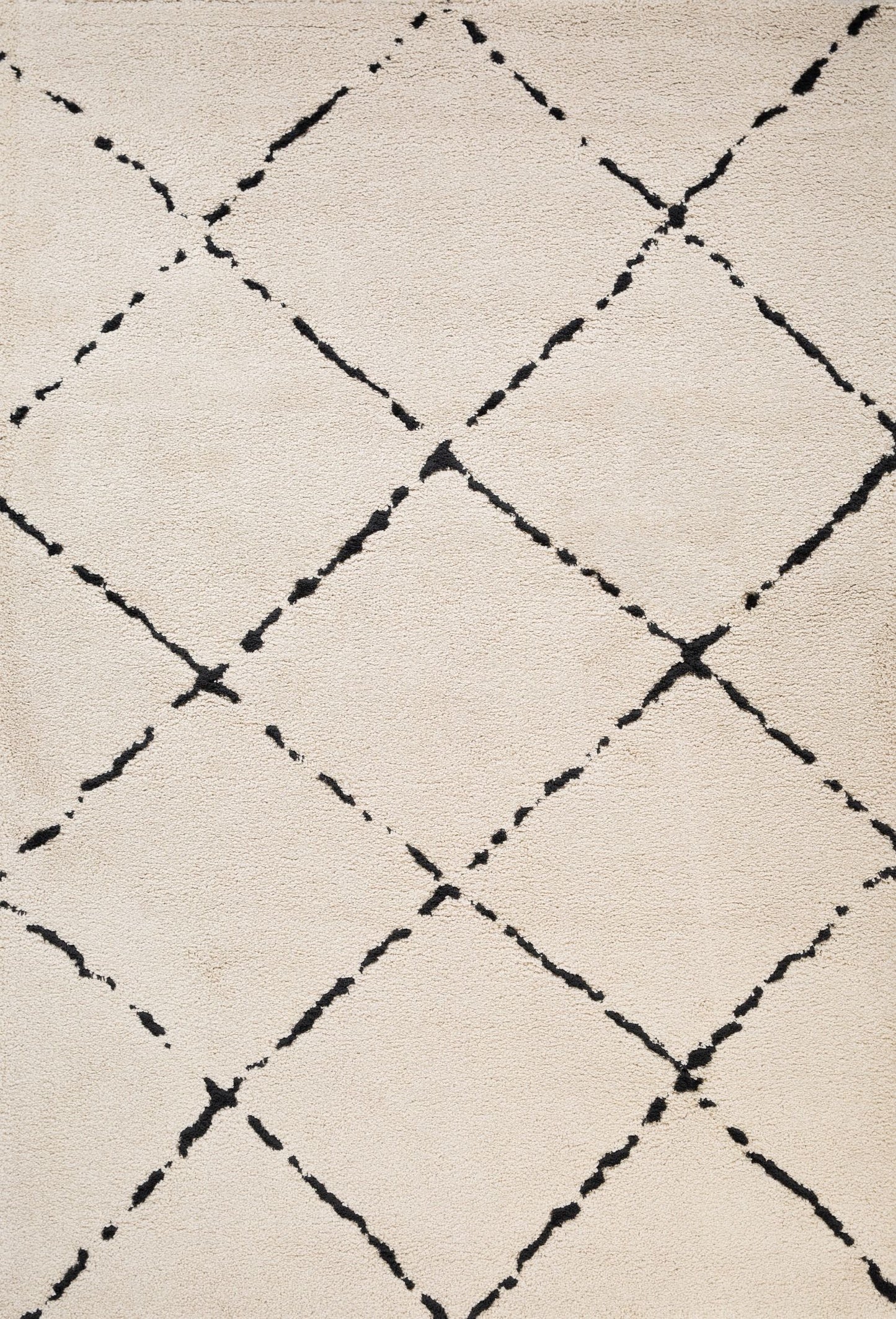 Luana Ivory Charcoal 4155 is a machine made polypropylene rug.  It features a shaggy pile with a moroccan boho inspired design. Colours Ivory with a charcoal diamond pattern. Sizes 160 X 230, 200 X 290, 240 X 320 and 300 X 390. Full.