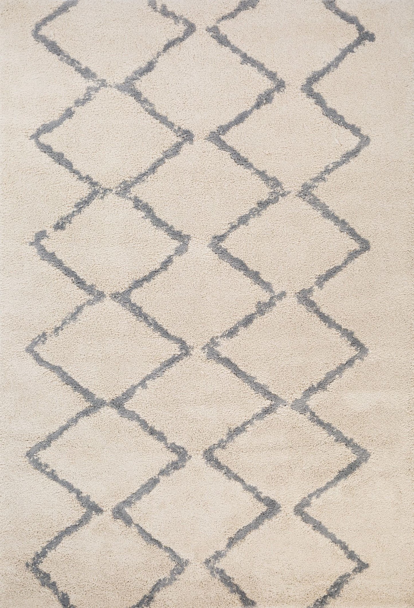 Luana Ivory Grey 701 is a machine made polypropylene rug.  It features a shaggy pile with a moroccan boho inspired design. Colours Ivory with a grey diamond pattern. Sizes 160 X 230, 200 X 290, 240 X 320 and 300 X 390. Full.