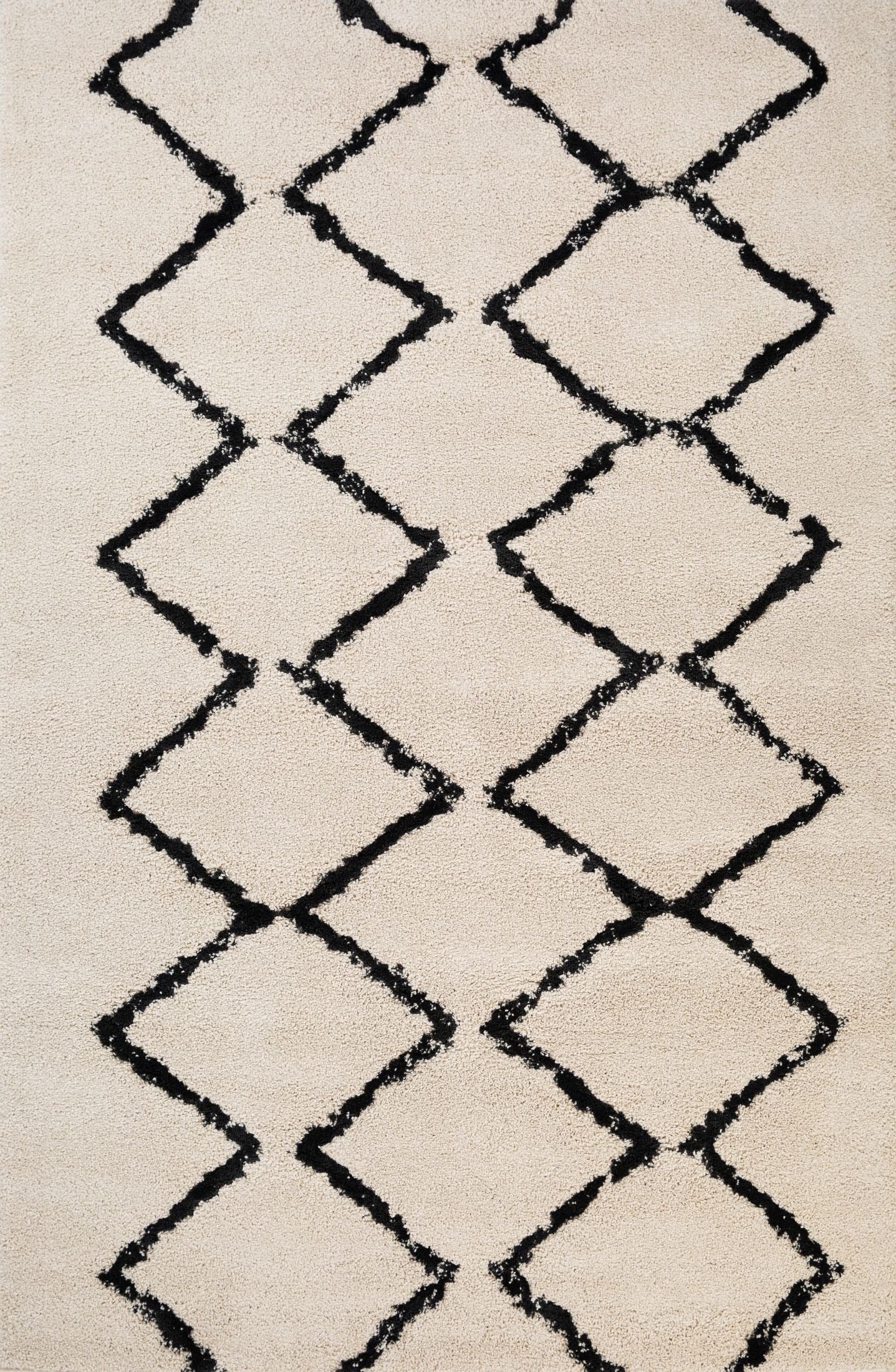 Luana Classic Ivory Charcoal is a machine made polypropylene rug.  It features a shaggy pile with a moroccan boho inspired design. Colours Ivory with a charcoal diamond pattern. Sizes 160 X 230, 200 X 290, 240 X 320 and 300 X 390. Top.