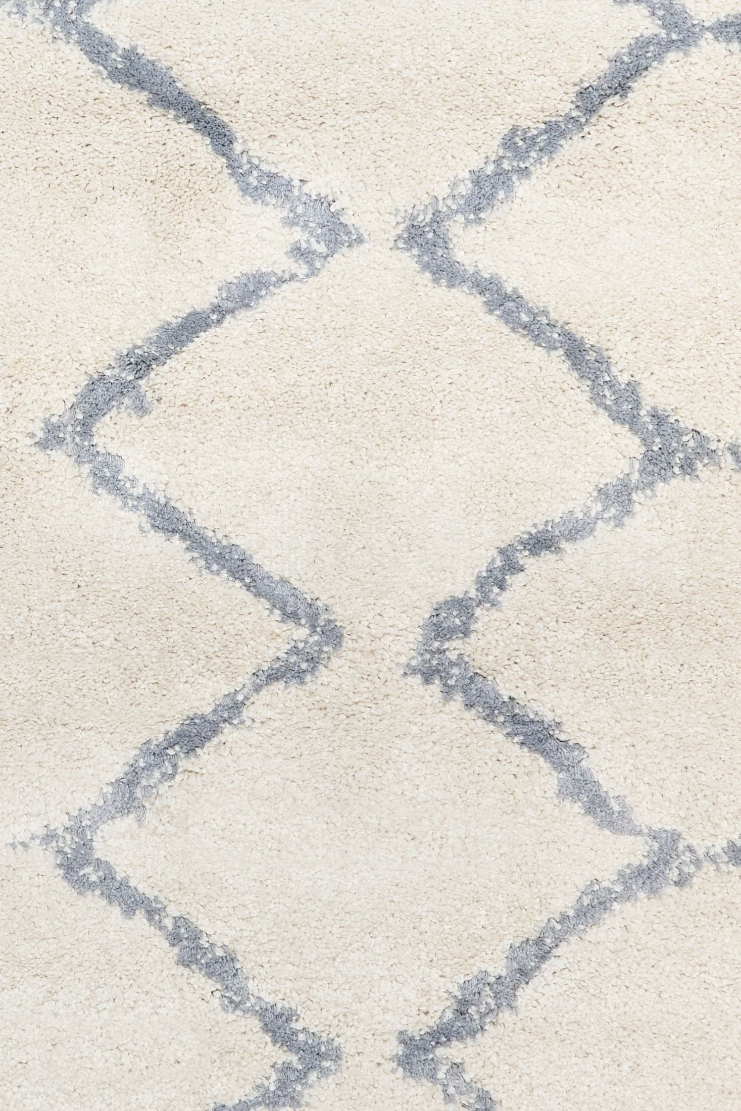 Luana Classic Ivory Grey is a machine made polypropylene rug.  It features a shaggy pile with a moroccan boho inspired design. Colours Ivory with a grey diamond pattern. Sizes 160 X 230, 200 X 290, 240 X 320 and 300 X 390. Close.