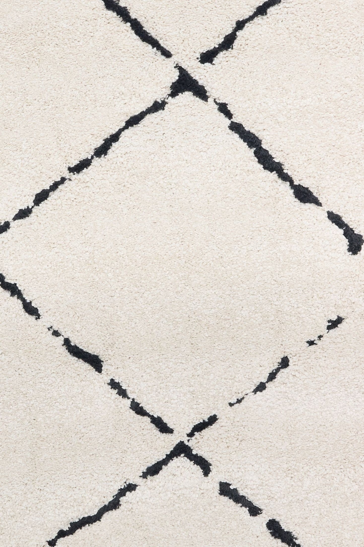 Luana Diamond Ivory Charcoal is a machine made polypropylene rug.  It features a shaggy pile with a moroccan boho inspired design. Colours Ivory with a charcoal diamond pattern. Sizes 160 X 230, 200 X 290, 240 X 320 and 300 X 390. Close.