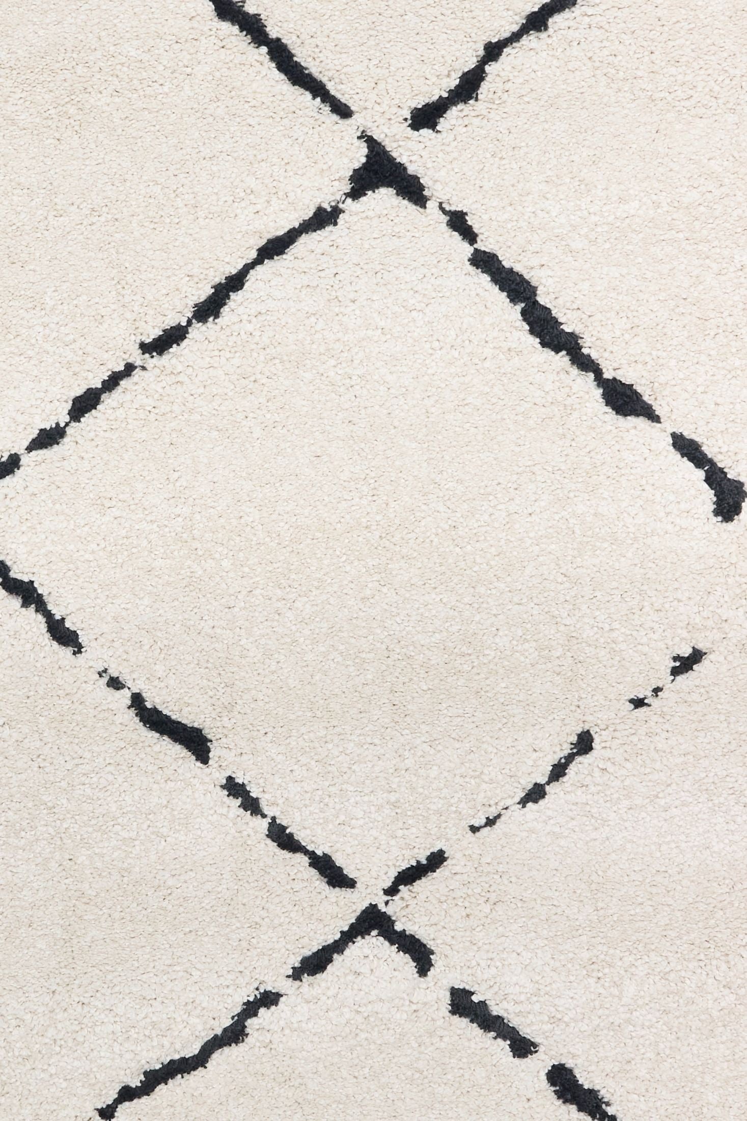 Luana Diamond Ivory Charcoal is a machine made polypropylene rug.  It features a shaggy pile with a moroccan boho inspired design. Colours Ivory with a charcoal diamond pattern. Sizes 160 X 230, 200 X 290, 240 X 320 and 300 X 390. Close.
