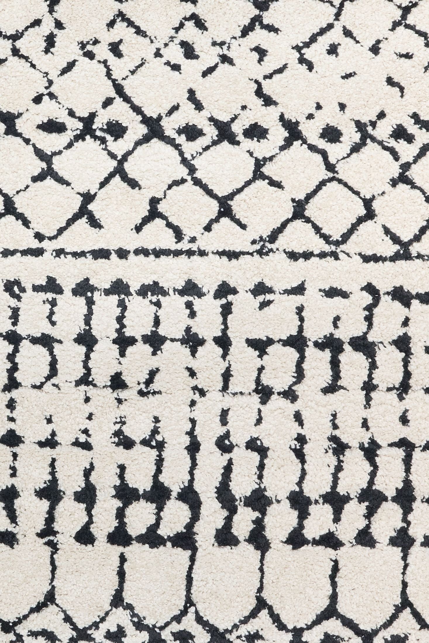 Luana Ivory Charcoal 71 is a machine made polypropylene rug.  It features a shaggy pile with a moroccan boho inspired design. Colours Ivory with a charcoal tribal pattern. Sizes 160 X 230, 200 X 290, 240 X 320 and 300 X 390. Close.