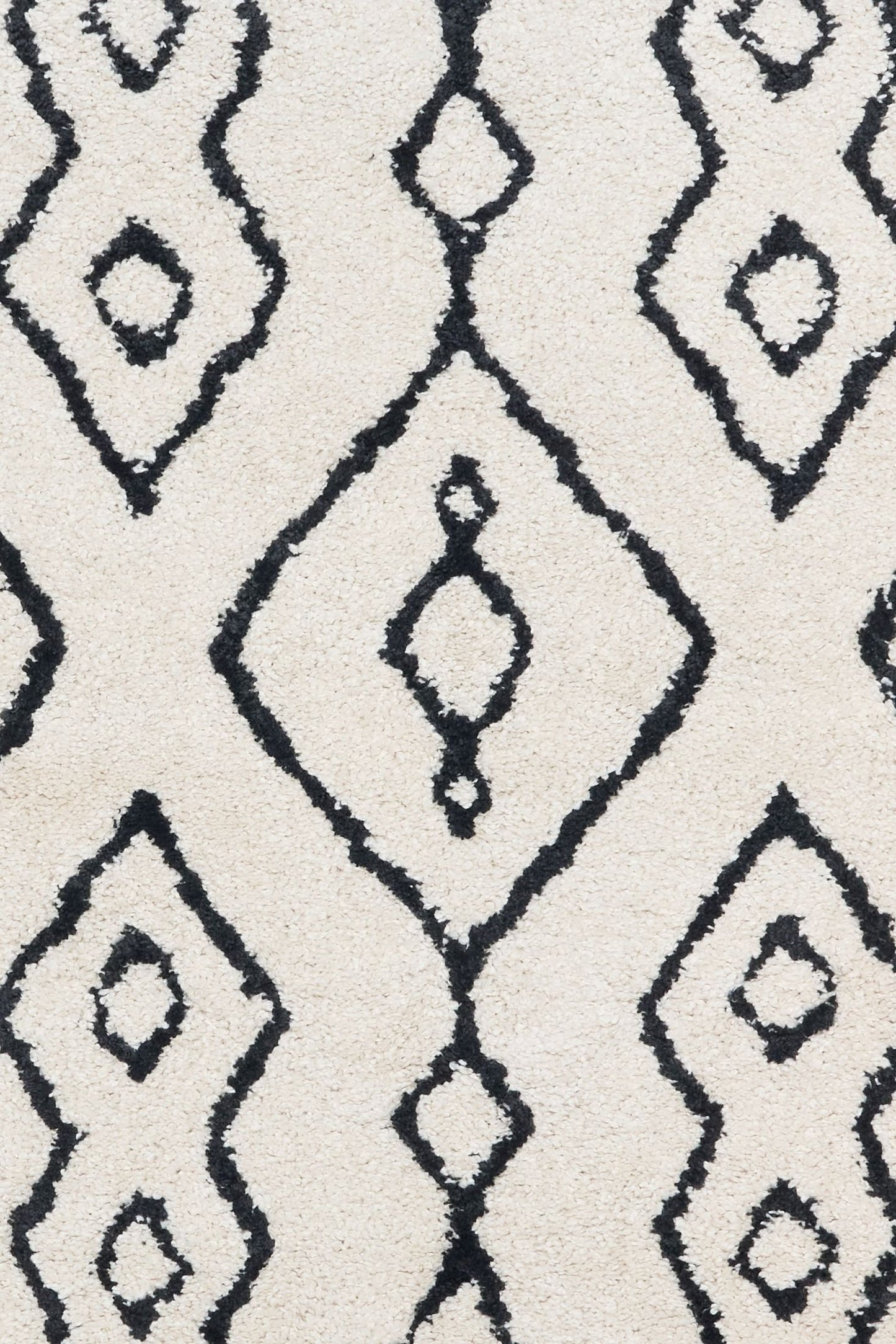 Luana Ivory Charcoal 8020 is a machine made polypropylene rug.  It features a shaggy pile with a moroccan boho inspired design. Colours Ivory with a charcoal moroccan inspired diamond pattern. Sizes 160 X 230, 200 X 290, 240 X 320 and 300 X 390. Close.