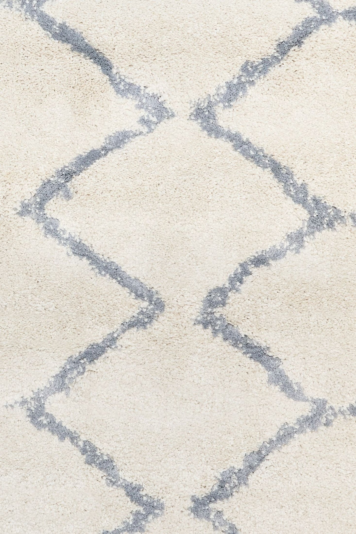 Luana Ivory Grey 701 is a machine made polypropylene rug.  It features a shaggy pile with a moroccan boho inspired design. Colours Ivory with a grey diamond pattern. Sizes 160 X 230, 200 X 290, 240 X 320 and 300 X 390. Close.