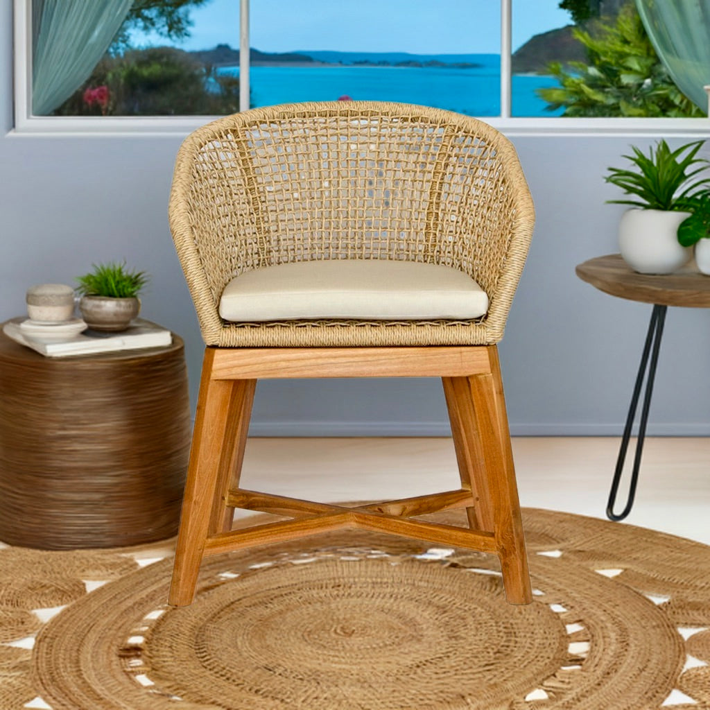 The Mahoe Dining Chair. Teak legs, durable rope sides, and UV-resistant cushions add a touch of coastal luxury. Styled.