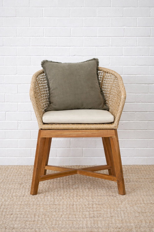 The Mahoe Dining Chair. Teak legs, durable rope sides, and UV-resistant cushions add a touch of coastal luxury. Styled.
