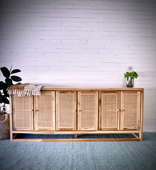 The Manzanita 6 Door Buffet is a contemporary and coastal four-door sideboard crafted from sustainable teak. The sideboard features open mesh rattan doors. Colour natural. Measures 2200 length X 400 depth X 900 height. Front Styled.
