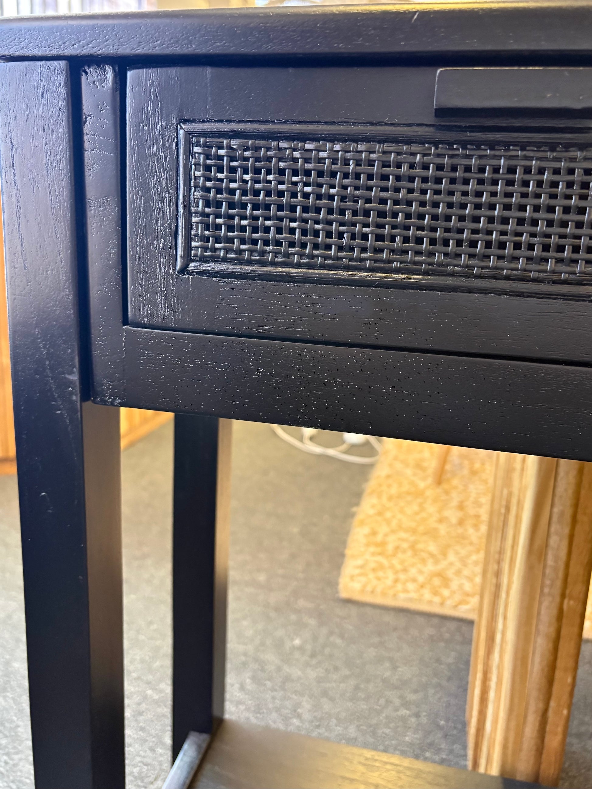 The Milan - 1 Drawer Black console boasts coastal and contemporary style. Crafted from sustainable white cedar timber, it features 1 drawer, on wooden runners, and an open mesh rattan drawer face. Colour Black. Measures 800 length X 250 depth X 750 height. Side.