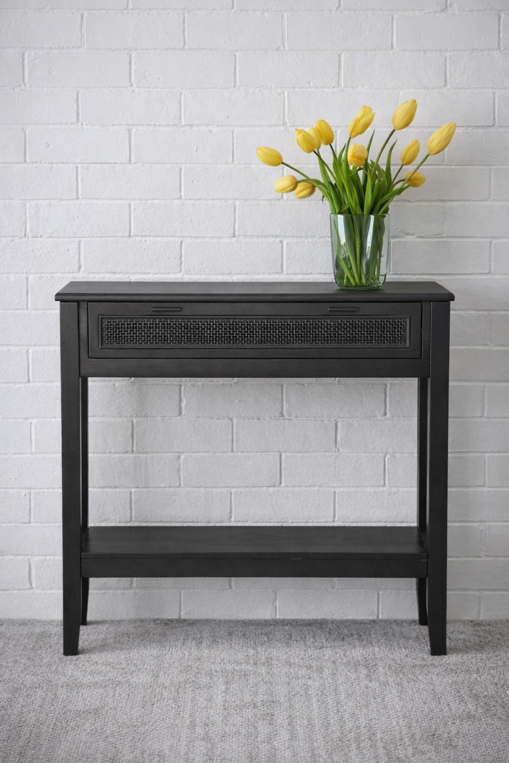 The Milan - 1 Drawer Black console boasts coastal and contemporary style. Crafted from sustainable white cedar timber, it features 1 drawer, on wooden runners, and an open mesh rattan drawer face. Colour Black. Measures 800 length X 250 depth X 750 height. Front Styled.