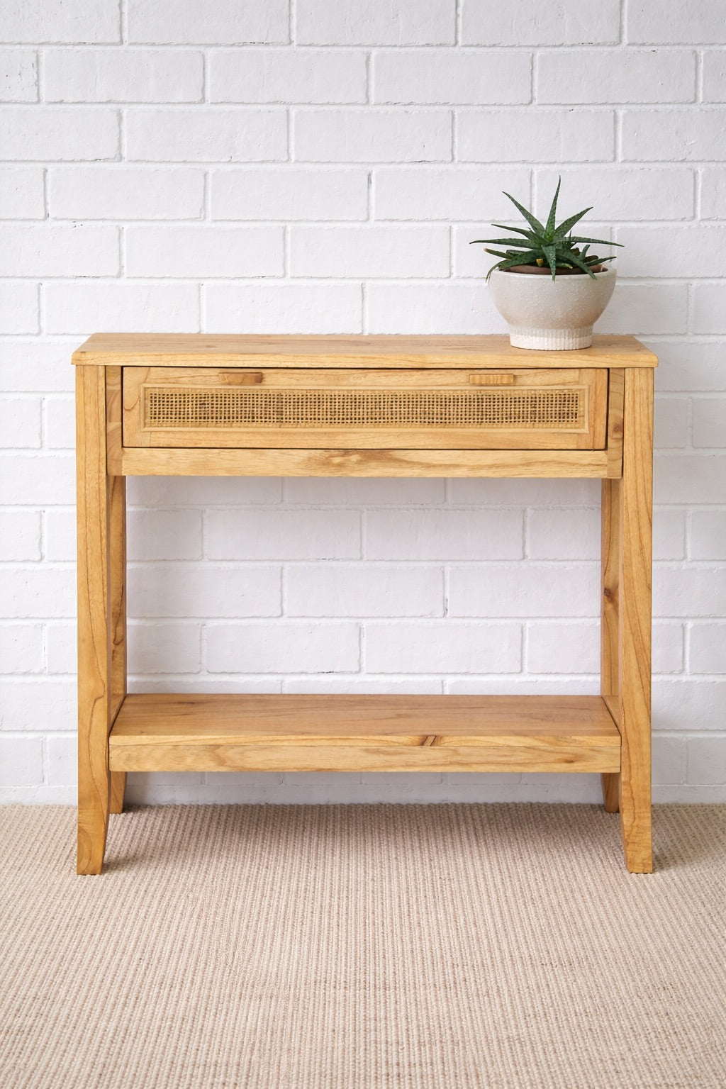 The Milan - 1 Drawer Natural console boasts coastal and contemporary style. Crafted from sustainable white cedar timber, it features 1 drawer, on wooden runners, and an open mesh rattan drawer face. Colour Natural. Measures 800 length X 250 depth X 750 height. Styled.