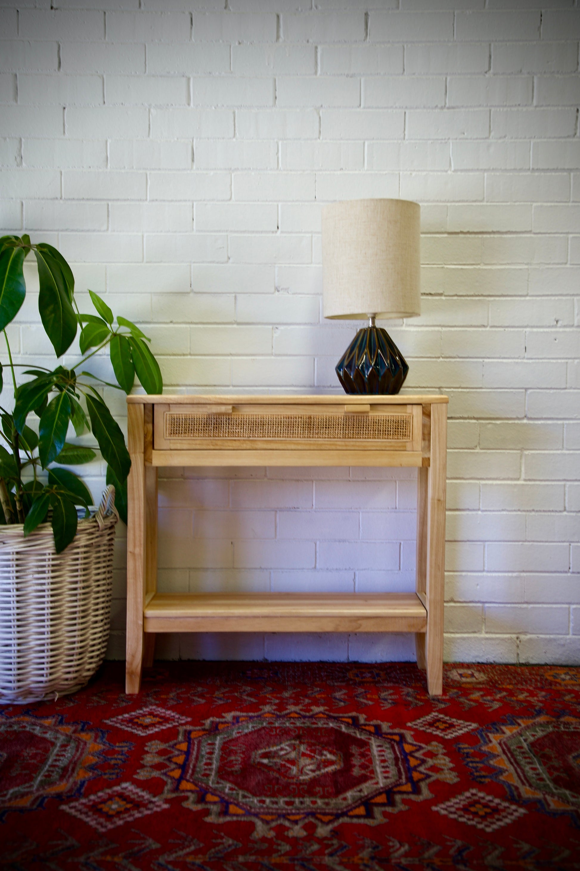 The Milan - 1 Drawer Natural console boasts coastal and contemporary style. Crafted from sustainable white cedar timber, it features 1 drawer, on wooden runners, and an open mesh rattan drawer face. Colour Natural. Measures 800 length X 250 depth X 750 height. Front Styled.