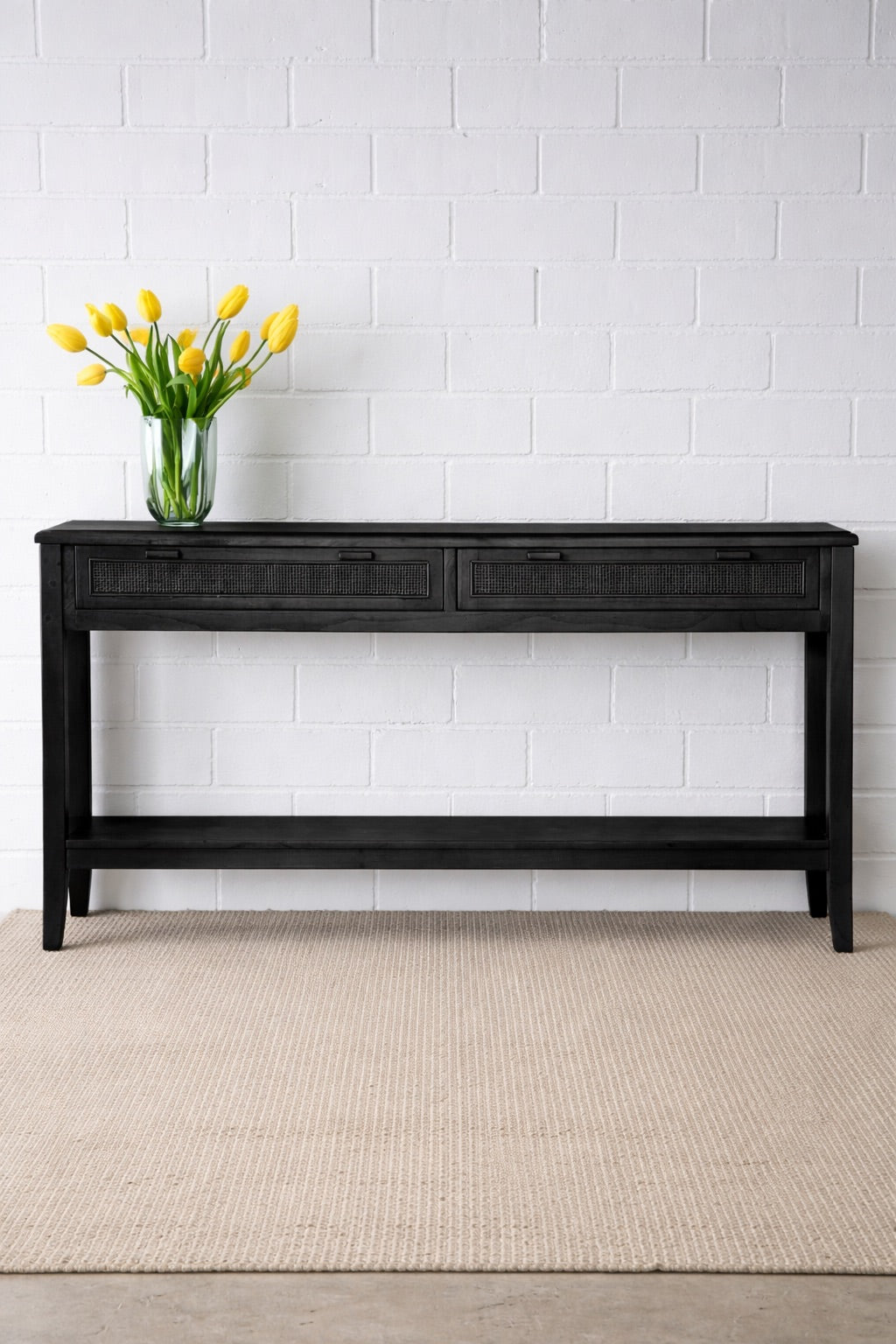 The Milan 2 Drawer Black console boasts coastal and contemporary style. Crafted from sustainable white cedar timber, it features 2 drawers, on wooden runners, and an open mesh rattan drawer face. Colour Black. Measures 1500 length X 250 depth X 750 height. Front Styled.