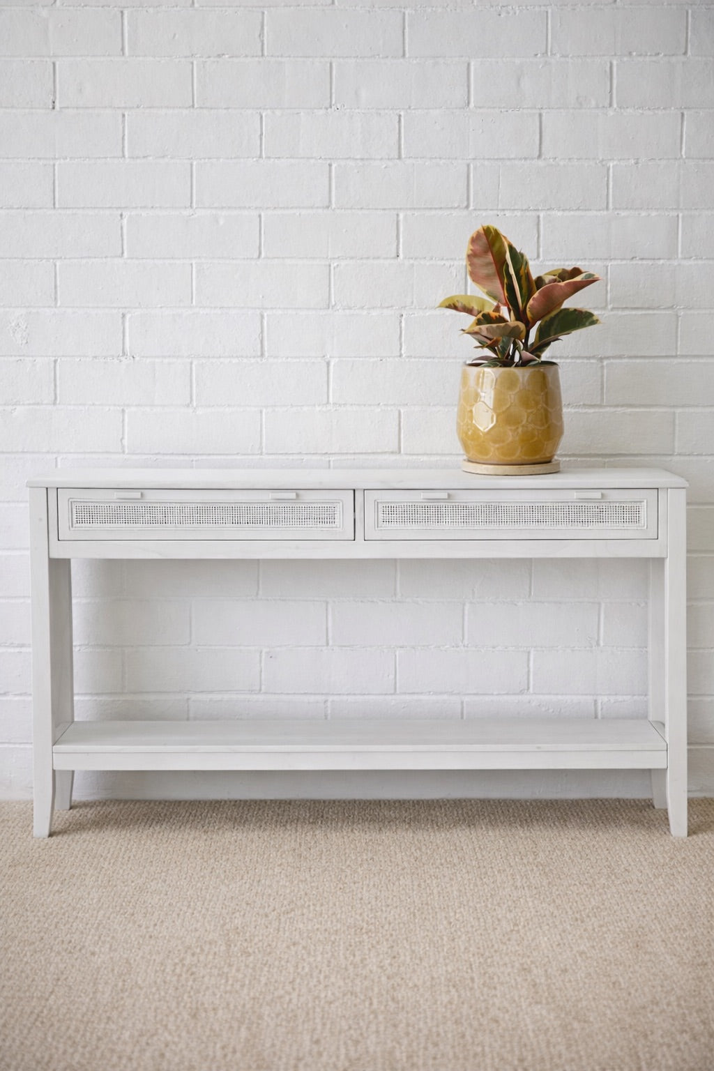 The Milan - 2 Drawer White console boasts coastal and contemporary style. Crafted from sustainable white cedar timber, it features 2 drawers, on wooden runners, and an open mesh rattan drawer face. Colour White. Measures 1500 length X 250 depth X 750 height. Front Styled.
