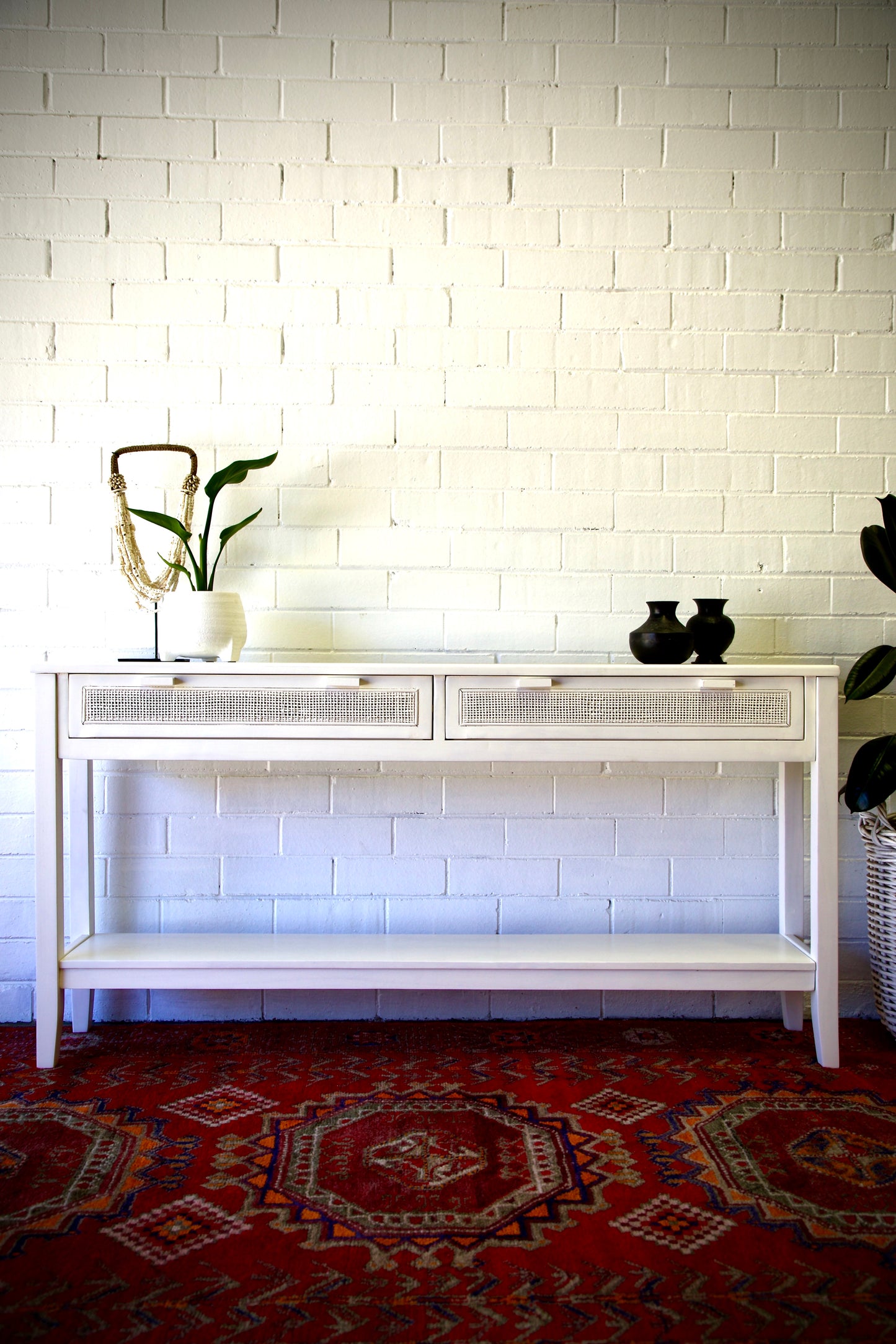 The Milan - 2 Drawer White console boasts coastal and contemporary style. Crafted from sustainable white cedar timber, it features 2 drawers, on wooden runners, and an open mesh rattan drawer face. Colour White. Measures 1500 length X 250 depth X 750 height. Front Styled.