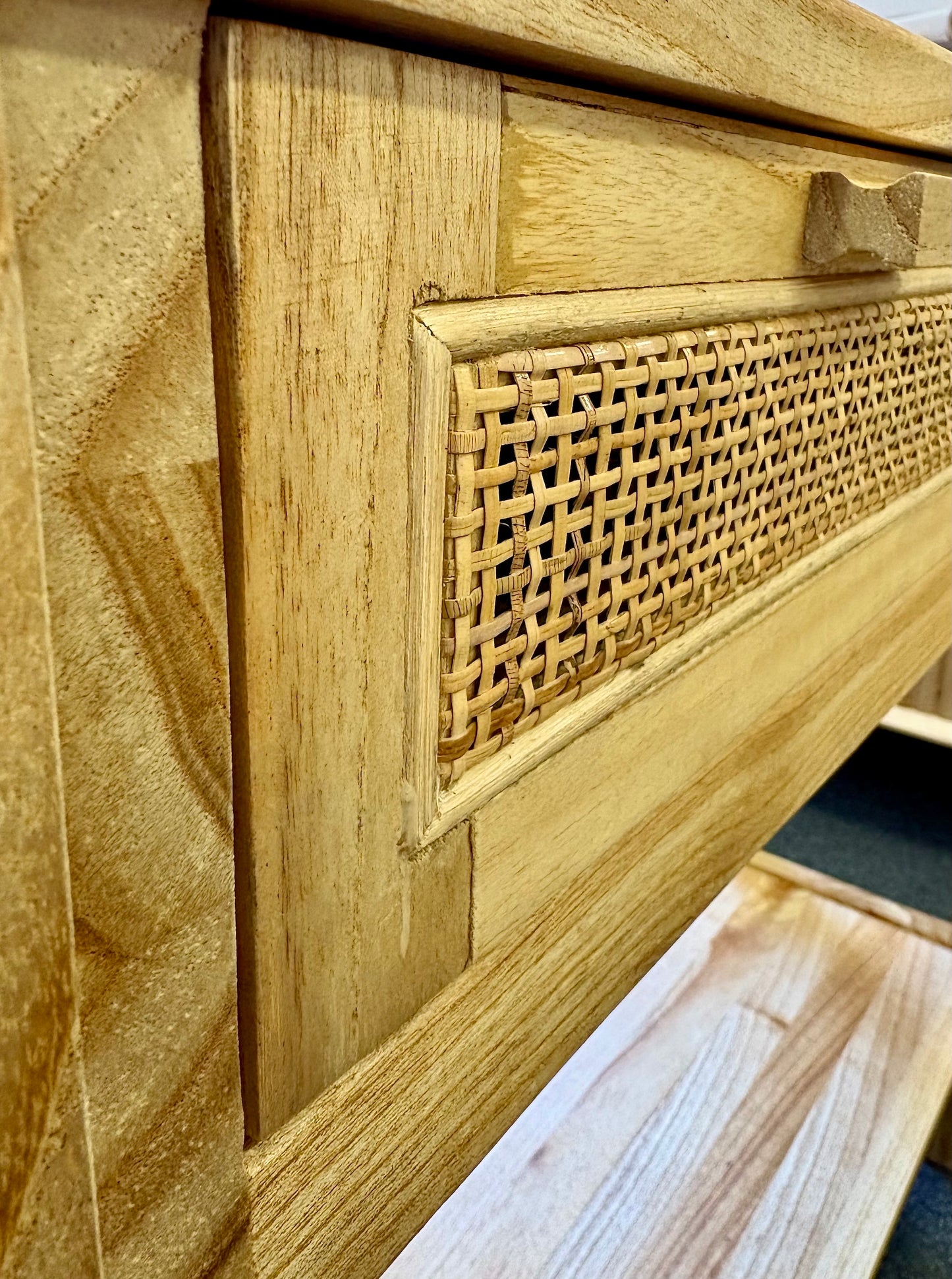 The Milan - 1 Drawer Natural console boasts coastal and contemporary style. Crafted from sustainable white cedar timber, it features 1 drawer, on wooden runners, and an open mesh rattan drawer face. Colour Natural. Measures 800 length X 250 depth X 750 height. Angle.