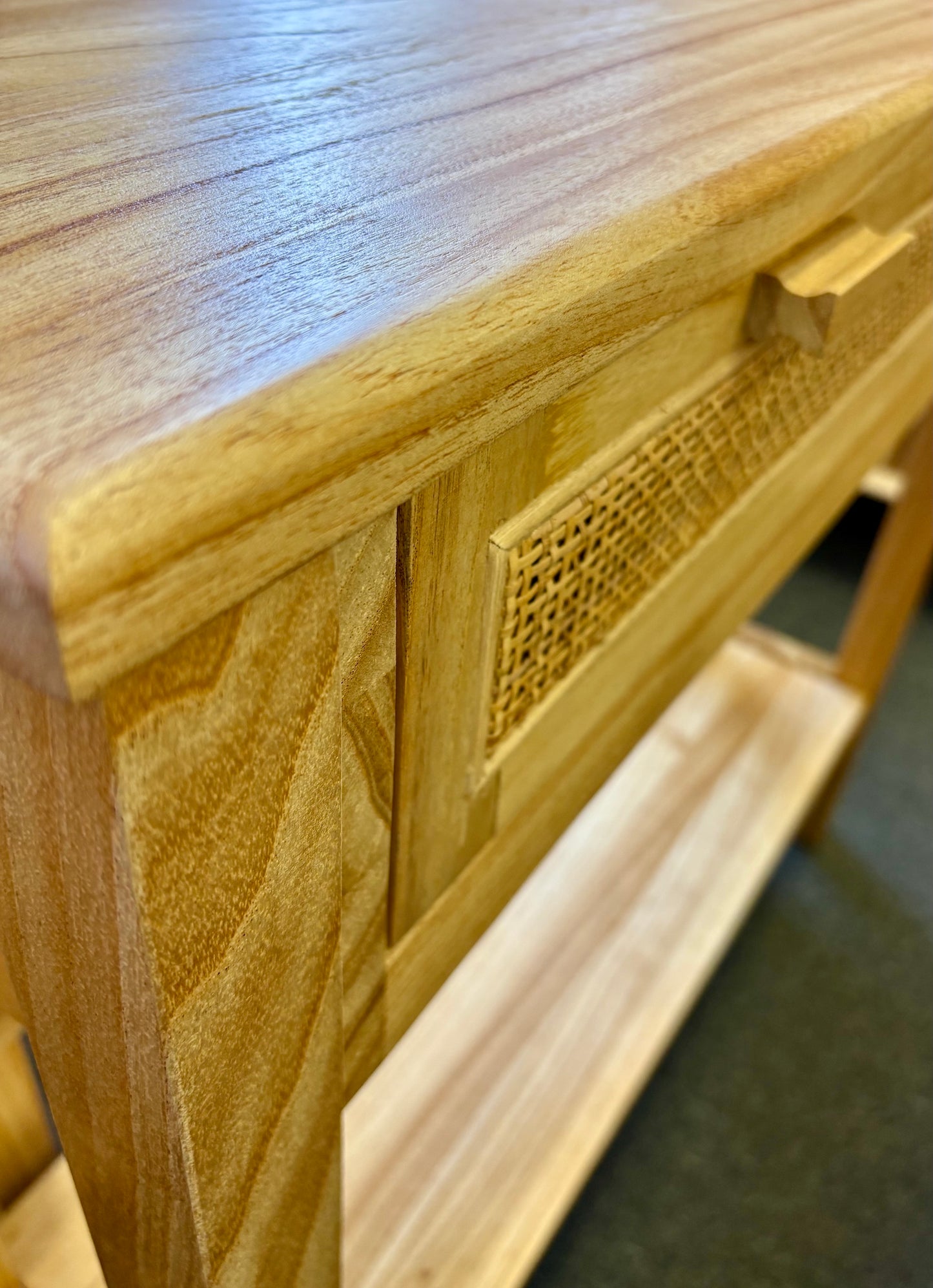 The Milan - 1 Drawer Natural console boasts coastal and contemporary style. Crafted from sustainable white cedar timber, it features 1 drawer, on wooden runners, and an open mesh rattan drawer face. Colour Natural. Measures 800 length X 250 depth X 750 height. Top Angle.