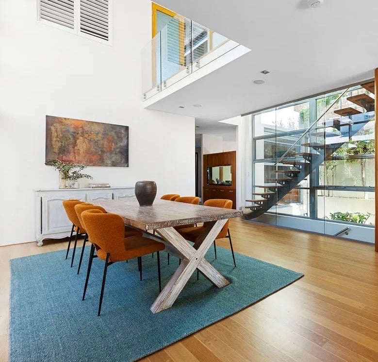 A minimal hand woven flatweave wool dining room rug styled in a coastal Perth home open planned dining room setting.