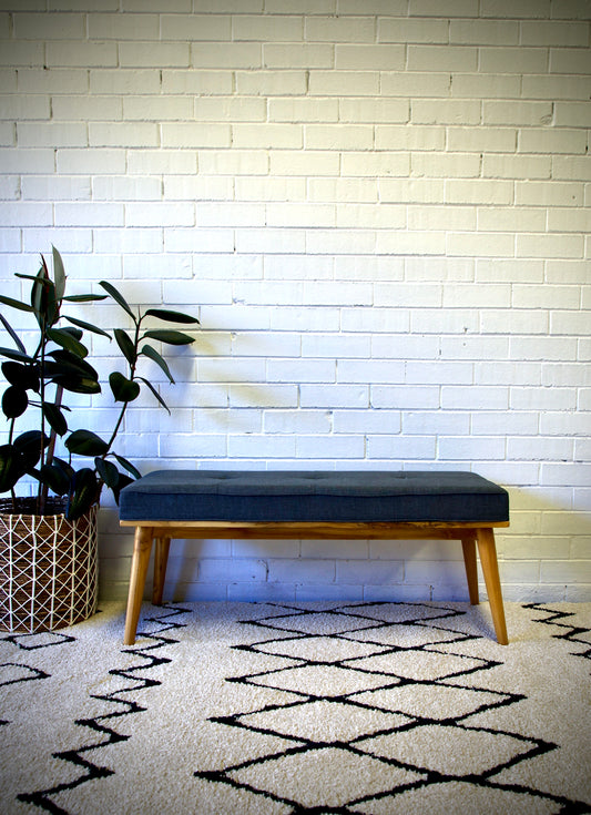The Mint Grey Bench is a contemporary bench with a cushioned seat and turned legs. Constructed from sturdy Sunkai Wood. Colours, natural legs, grey cushion. Measures  1100 wide X 400 depth X 470 height. Front Styled.
