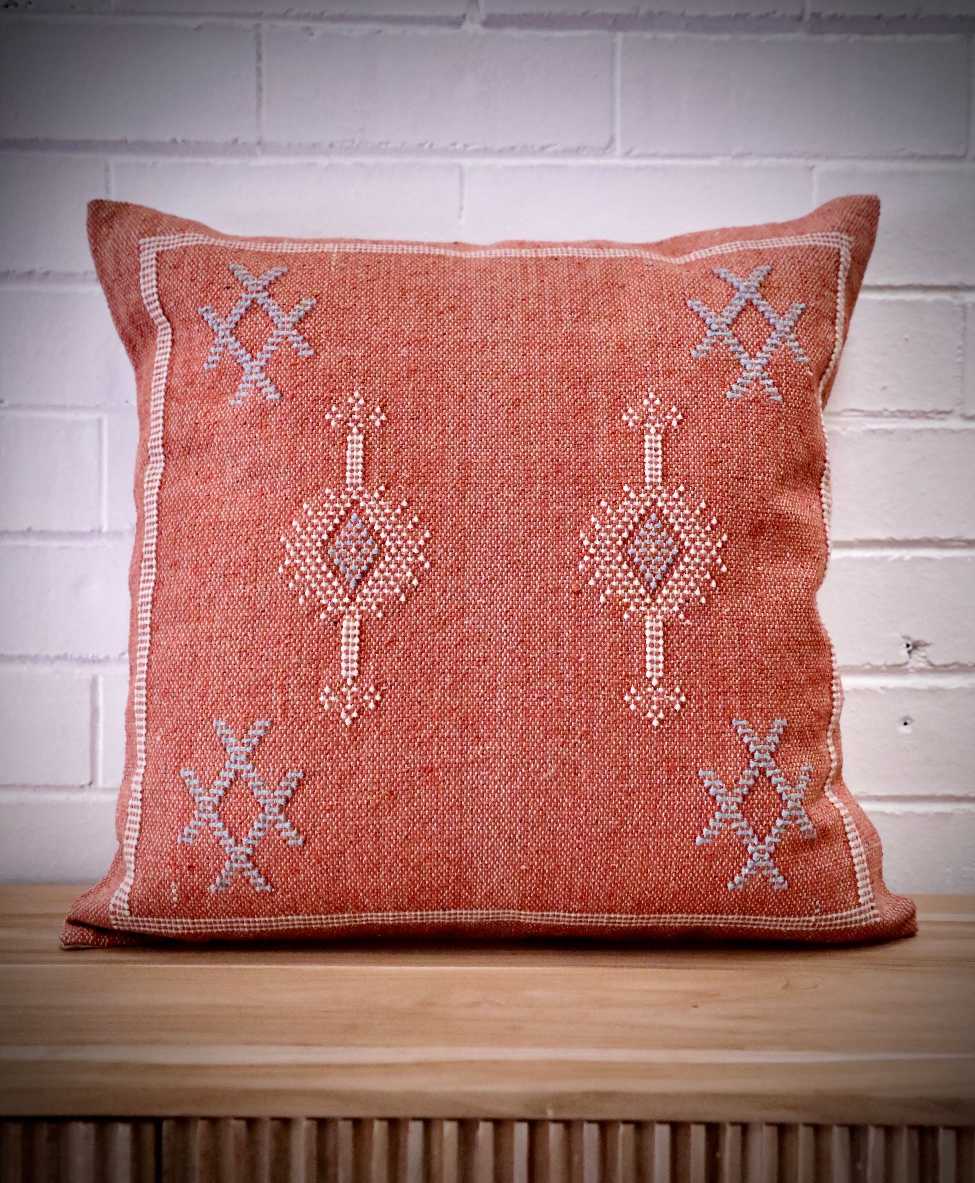 The Moroccan Burnt Orange Cushion is hand crafted in India. Features a cotton weave with hidden zip on the back. This Moroccan inspired design will bring a boho feel to any area. Colours, orange, cream and blues. Measures 50 X 50. Front.