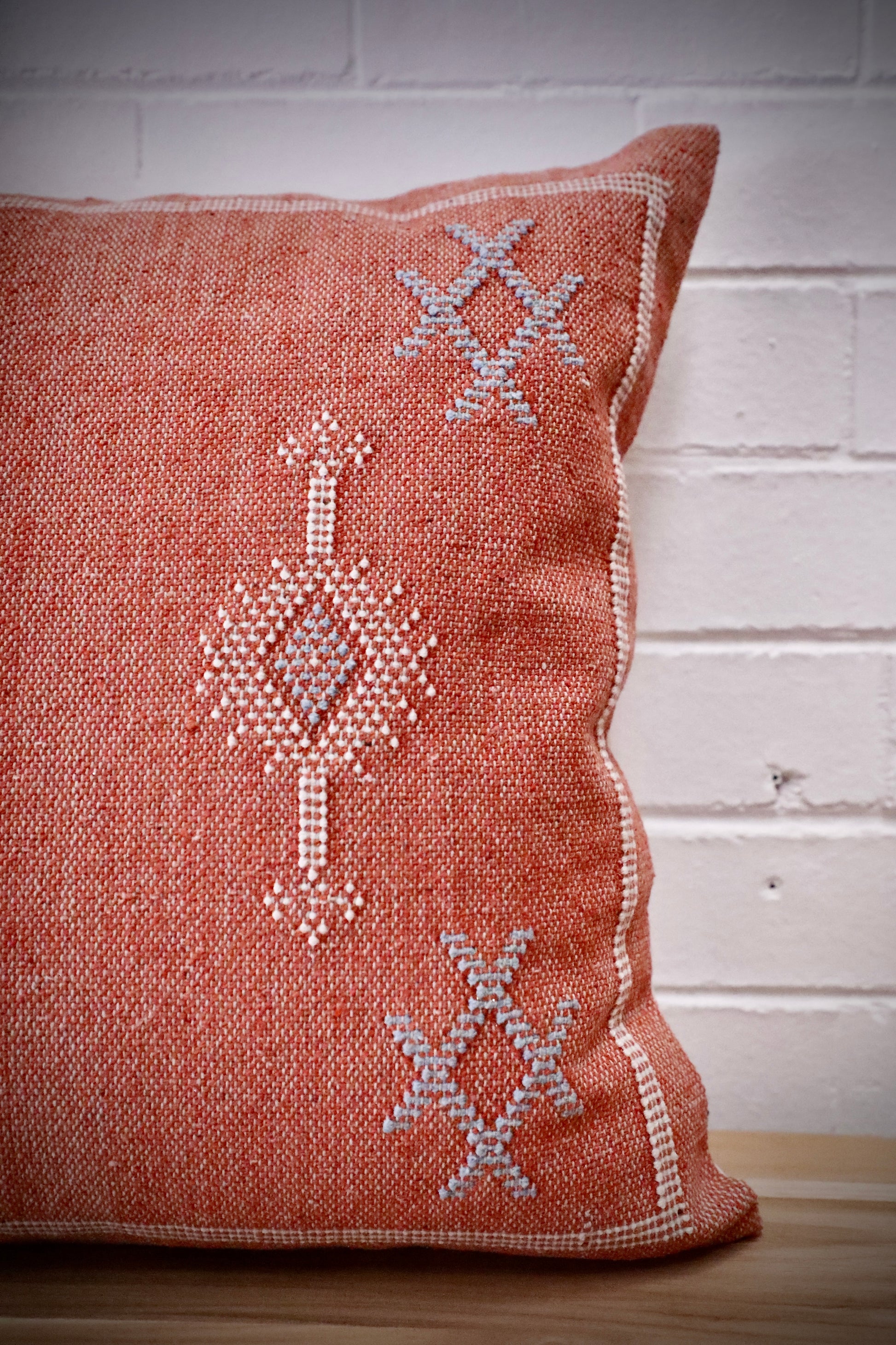 The Moroccan Burnt Orange Cushion is hand crafted in India. Features a cotton weave with hidden zip on the back. This Moroccan inspired design will bring a boho feel to any area. Colours, orange, cream and blues. Measures 50 X 50. Front Side.