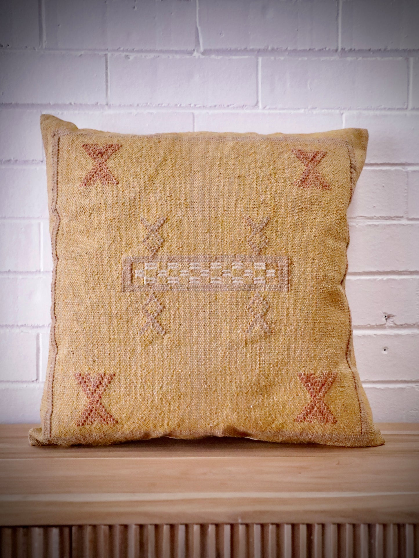 The Moroccan Mustard Yellow Cushion is hand made and features a cotton weave with hidden zip on the back. The Moroccan inspired motif's will bring a tribal feel to any area. Colours, light yellow, cream, brown and blues. Measures 50 X 50. Front.