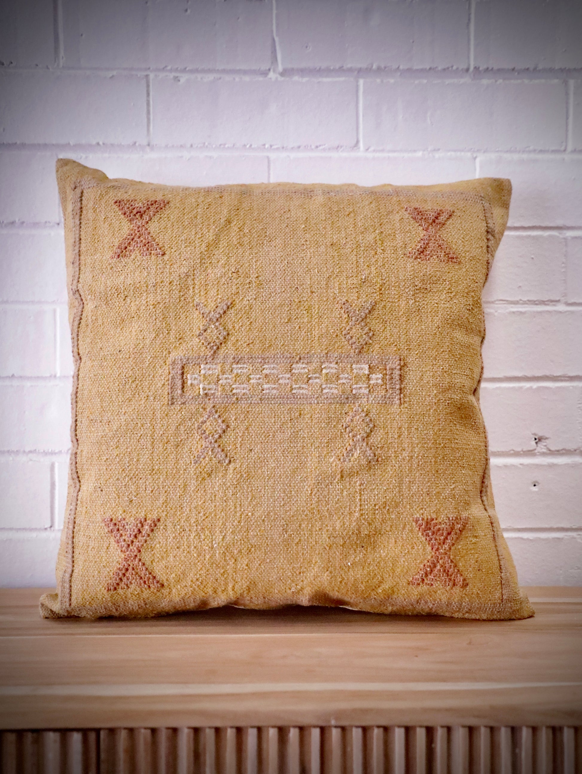 The Moroccan Mustard Yellow Cushion is hand made and features a cotton weave with hidden zip on the back. The Moroccan inspired motif's will bring a tribal feel to any area. Colours, light yellow, cream, brown and blues. Measures 50 X 50. Front.