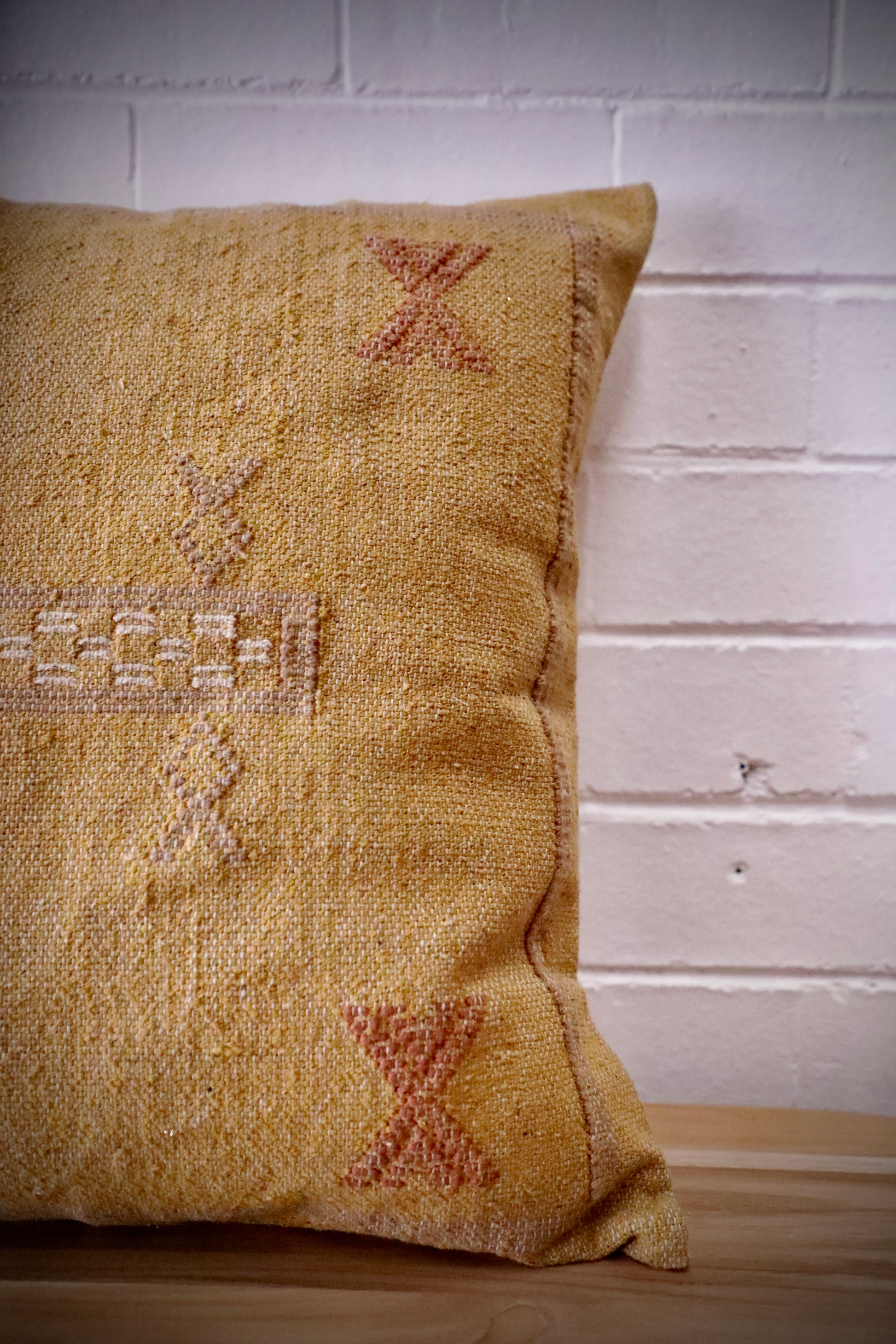 The Moroccan Mustard Yellow Cushion is hand made and features a cotton weave with hidden zip on the back. The Moroccan inspired motif's will bring a tribal feel to any area. Colours, light yellow, cream, brown and blues. Measures 50 X 50. Front Side.