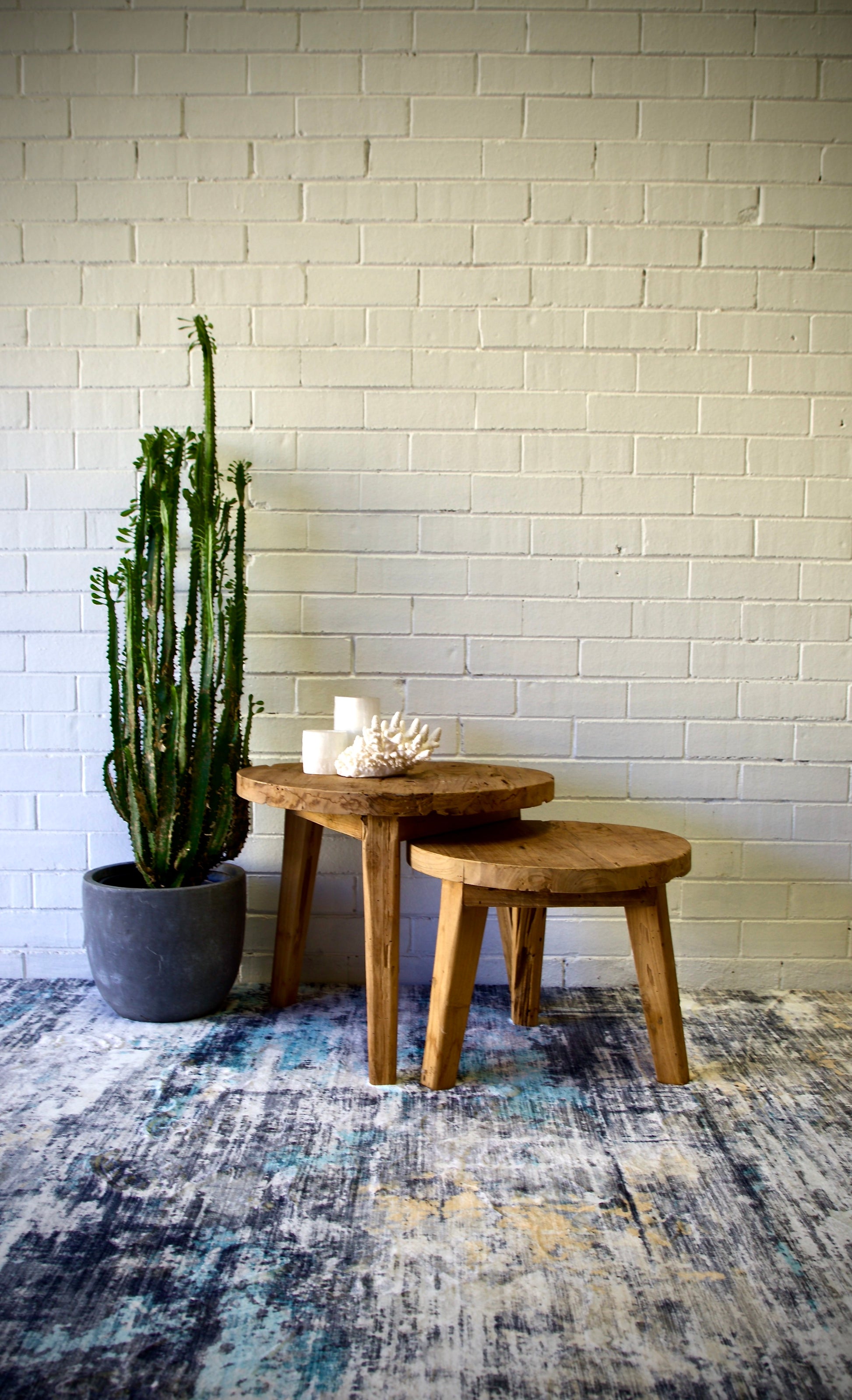 The Nara - Set of 2 Side Tables, are crafted from sustainable reclaimed Teak and feature round tops and semi-turned legs. Colour natural. Measures 600 diameter X 500 height (L) & 500 diameter X 400 height (S). Front Styled.
