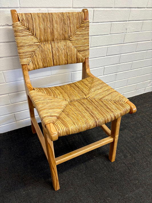 The Navajo Dining Chair is a coastal inspired dining chair. It features a teak frame and a woven pandan seat and back. Colour natural. Measures 450 wide X 540 depth X 470 seat height. Back height 850. Angle.