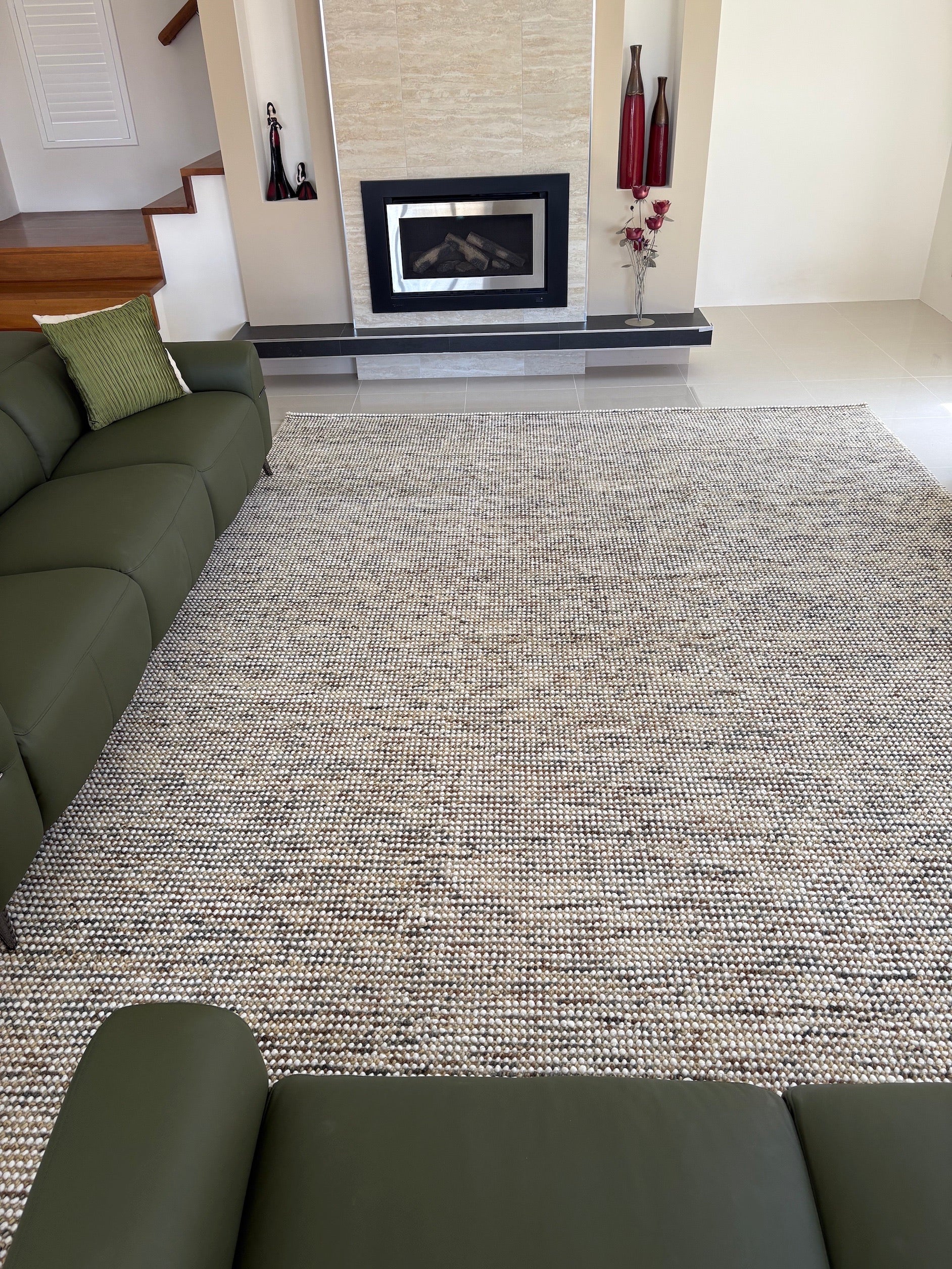 The Avlia Biege Hand woven rug styled in a modern Perth Living room.