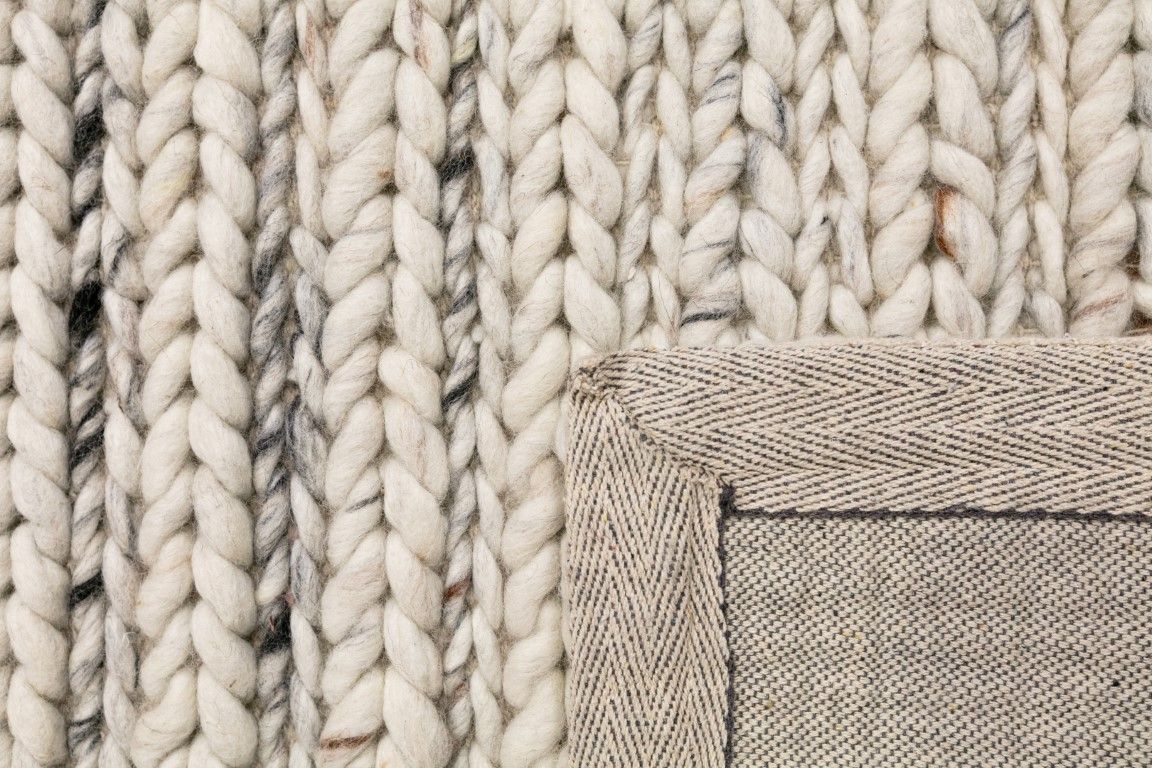 Oslo Greyology 1392 is a textured hand woven,  braided piled wool rug. Colours white with grey,  black and brown accents. Sizes 155 X 225, 200 X 290, 240 X 320 and 300 X 400. Fold.