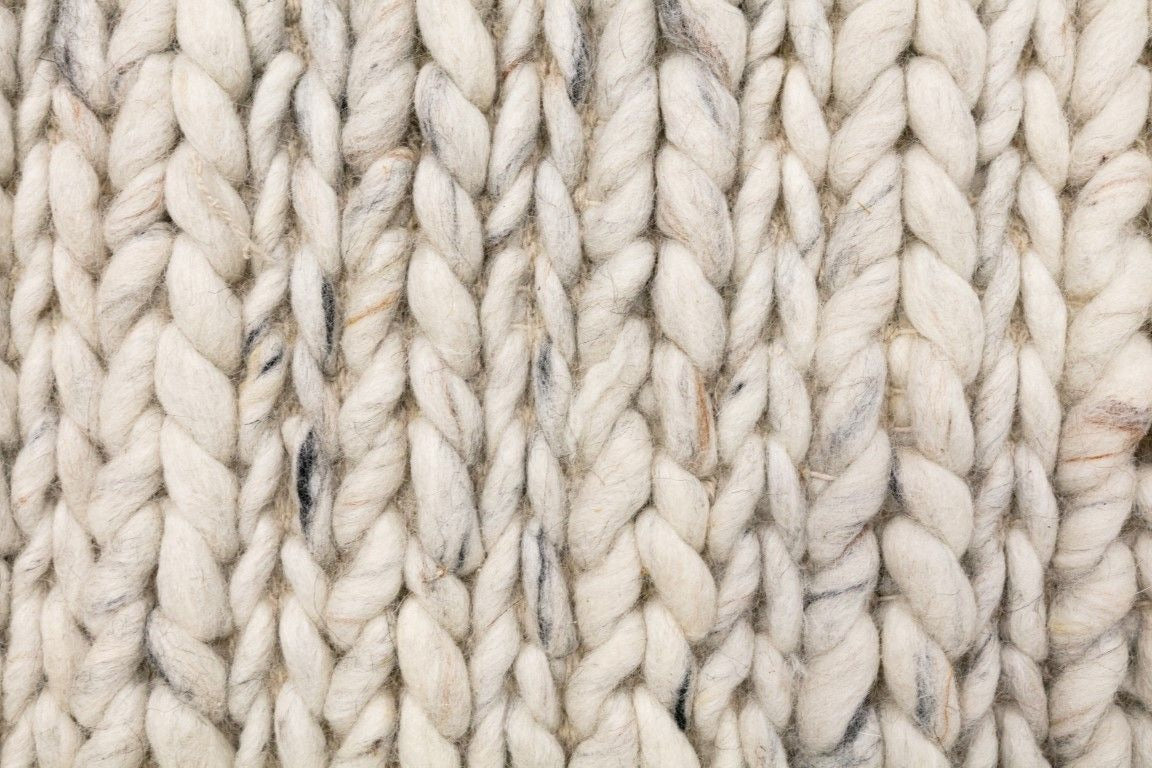 Oslo Braided is a textured hand woven,  braided piled wool rug. Colours white with grey,  black and brown accents. Sizes 155 X 225, 200 X 290, 240 X 320 and 300 X 400. Close.