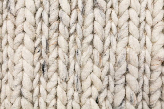 Oslo Braided is a textured hand woven,  braided piled wool rug. Colours white with grey,  black and brown accents. Sizes 155 X 225, 200 X 290, 240 X 320 and 300 X 400. Close.