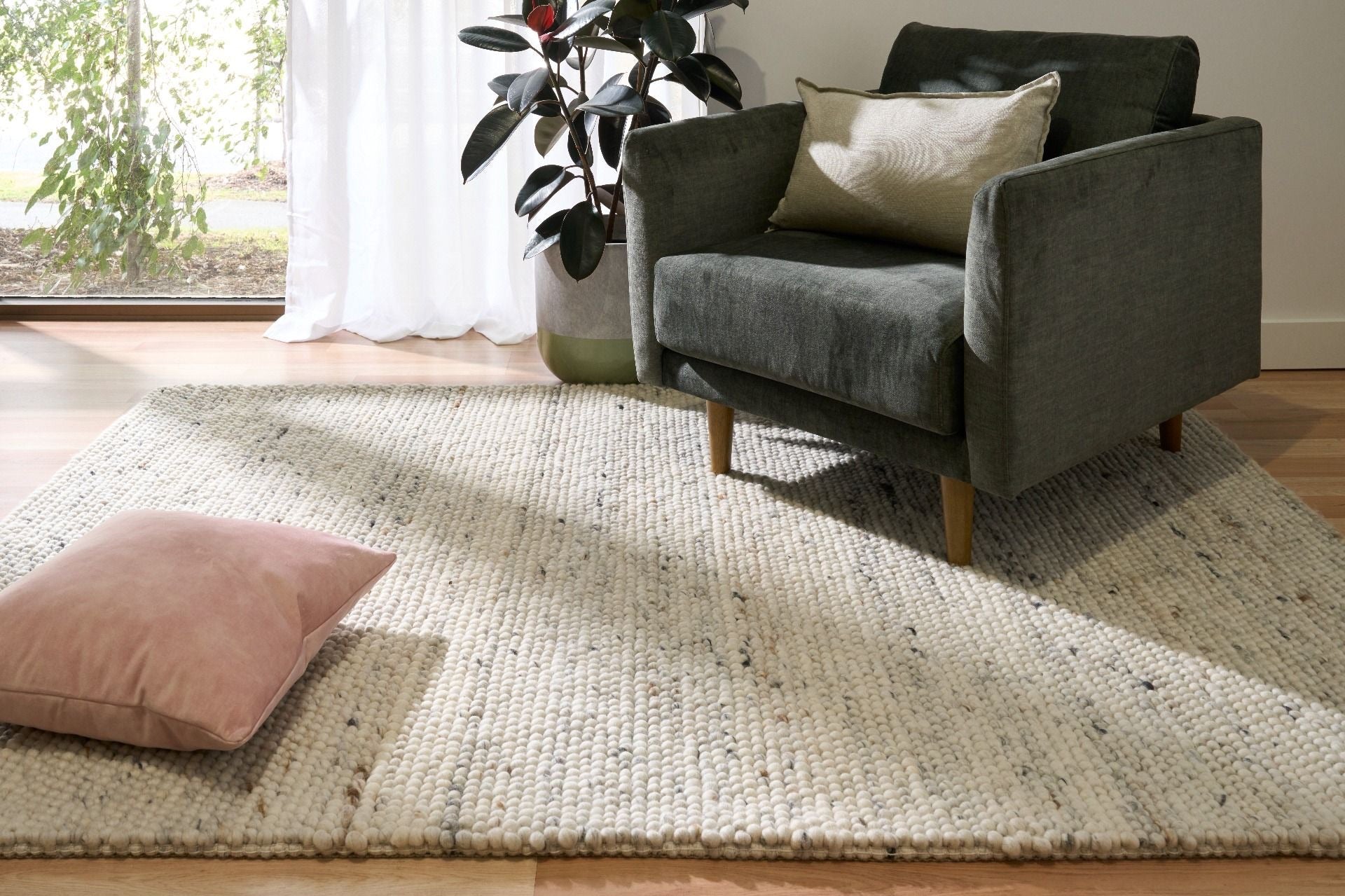 Oslo Bubble is a textured hand woven,  looped piled wool rug. Colours white with grey,  black and brown accents. Sizes 155 X 225, 200 X 290, 240 X 320 and 300 X 400. Life.