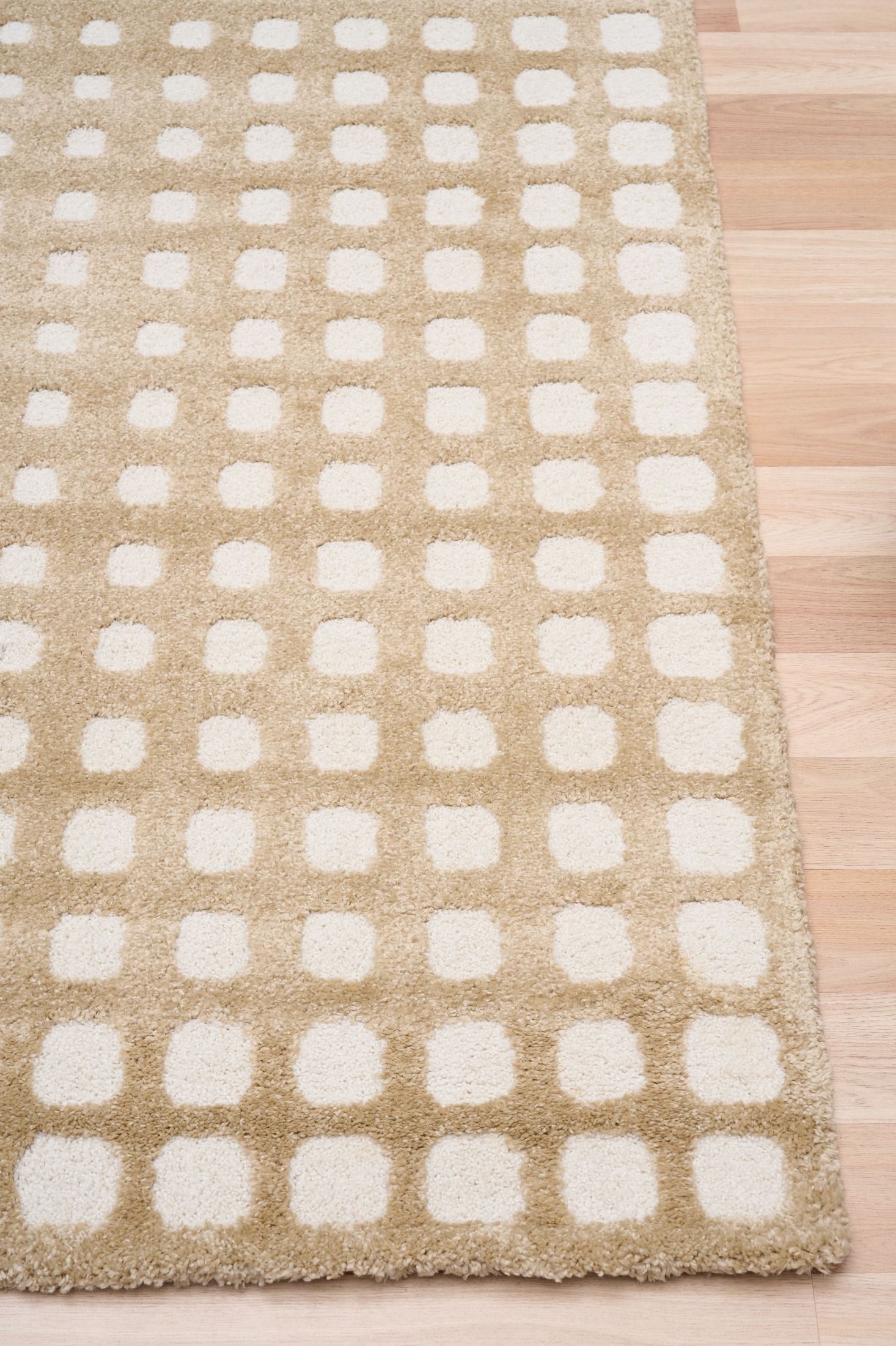 Osmond Squares Beige rug with soft square patterns in a neutral palette and a high-low textured finish. Colours Beige and Cream. Sizes 160 X 230, 200 X 290 and 240 X 340. Corner.