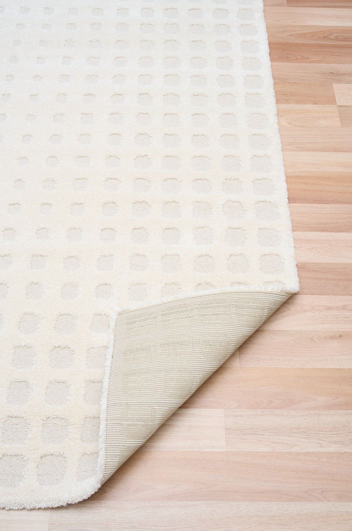Osmond Squares Ivory rug with soft square patterns in a neutral palette and a high-low textured finish. Colours Ivory and Light Grey. Sizes 160 X 230, 200 X 290 and 240 X 340. Fold.
