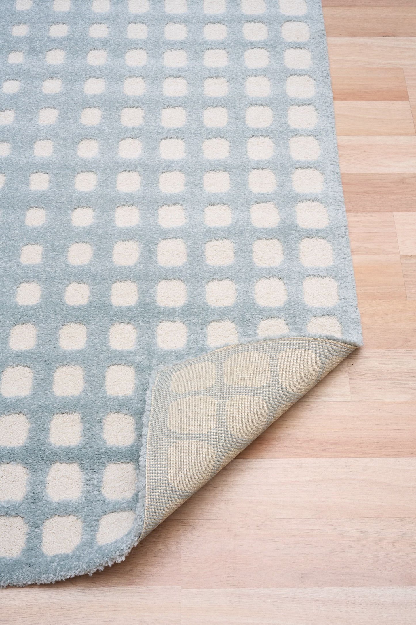 Osmond Squares Light Blue rug with soft square patterns in a neutral palette and a high-low textured finish. Colours Light Blue and Ivory. Sizes 160 X 230, 200 X 290 and 240 X 340. Fold.