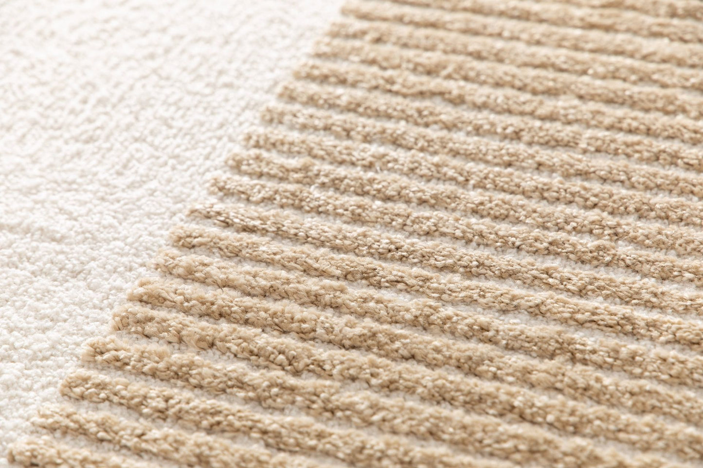 Osmond Waves Beige rug with soft geometric patterns in a neutral palette and a high-low textured finish. Colour Beige and Cream. Sizes 160 X 230, 200 X 290 and 240 X 340. Close.