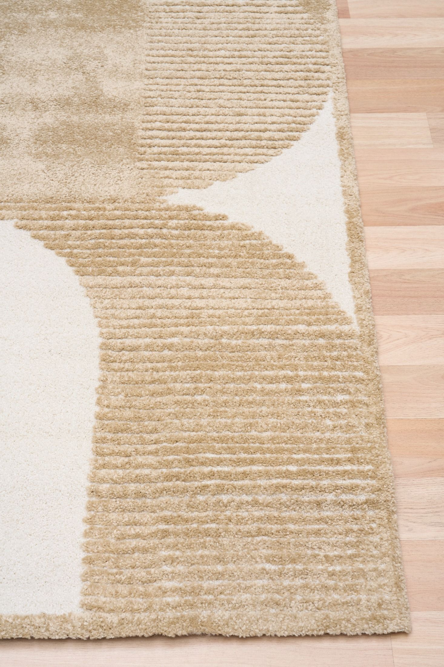 Osmond Waves Beige rug with soft geometric patterns in a neutral palette and a high-low textured finish. Colour Beige and Cream. Sizes 160 X 230, 200 X 290 and 240 X 340. Corner.