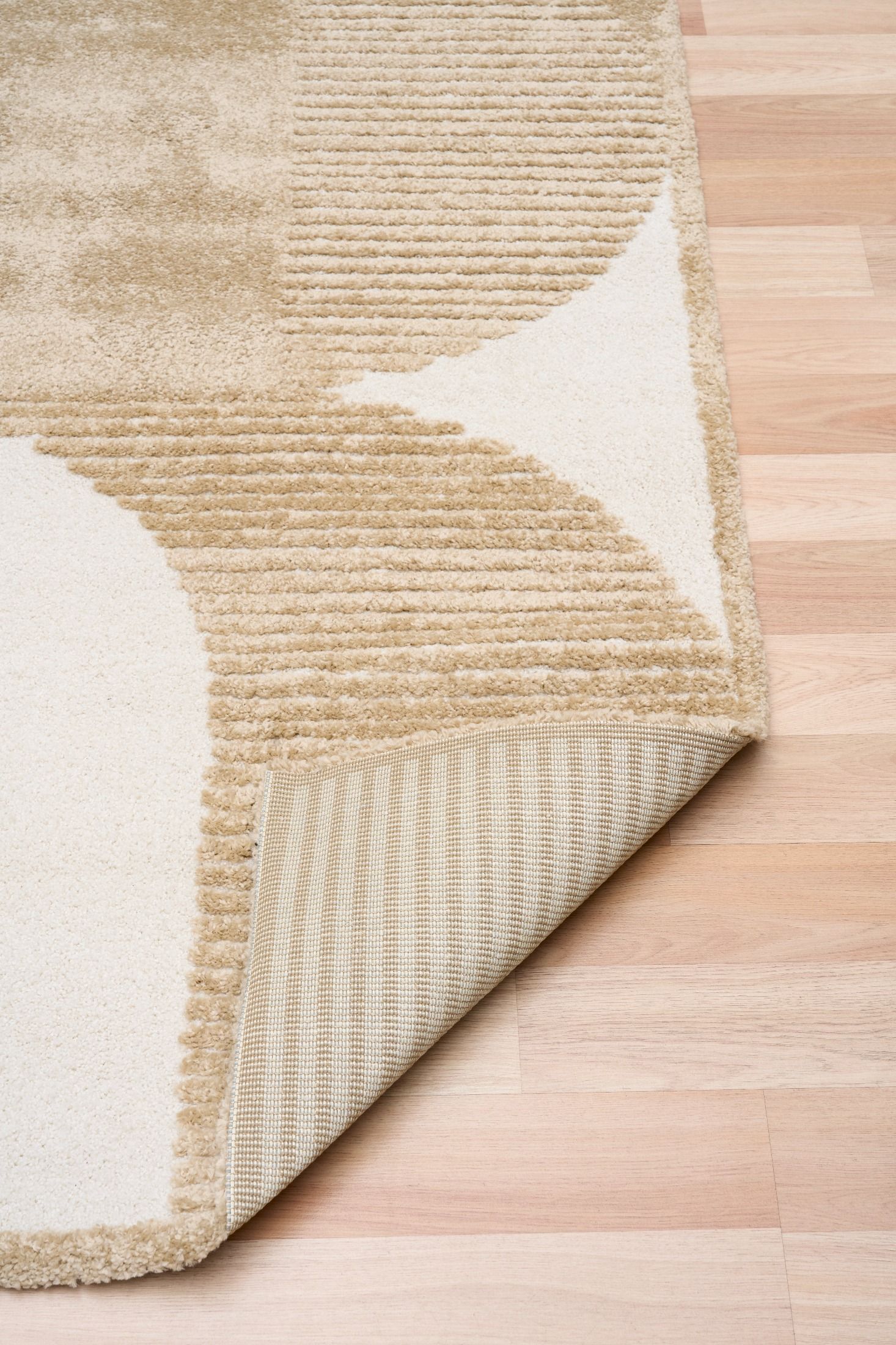 Osmond Waves Beige rug with soft geometric patterns in a neutral palette and a high-low textured finish. Colour Beige and Cream. Sizes 160 X 230, 200 X 290 and 240 X 340. Fold.