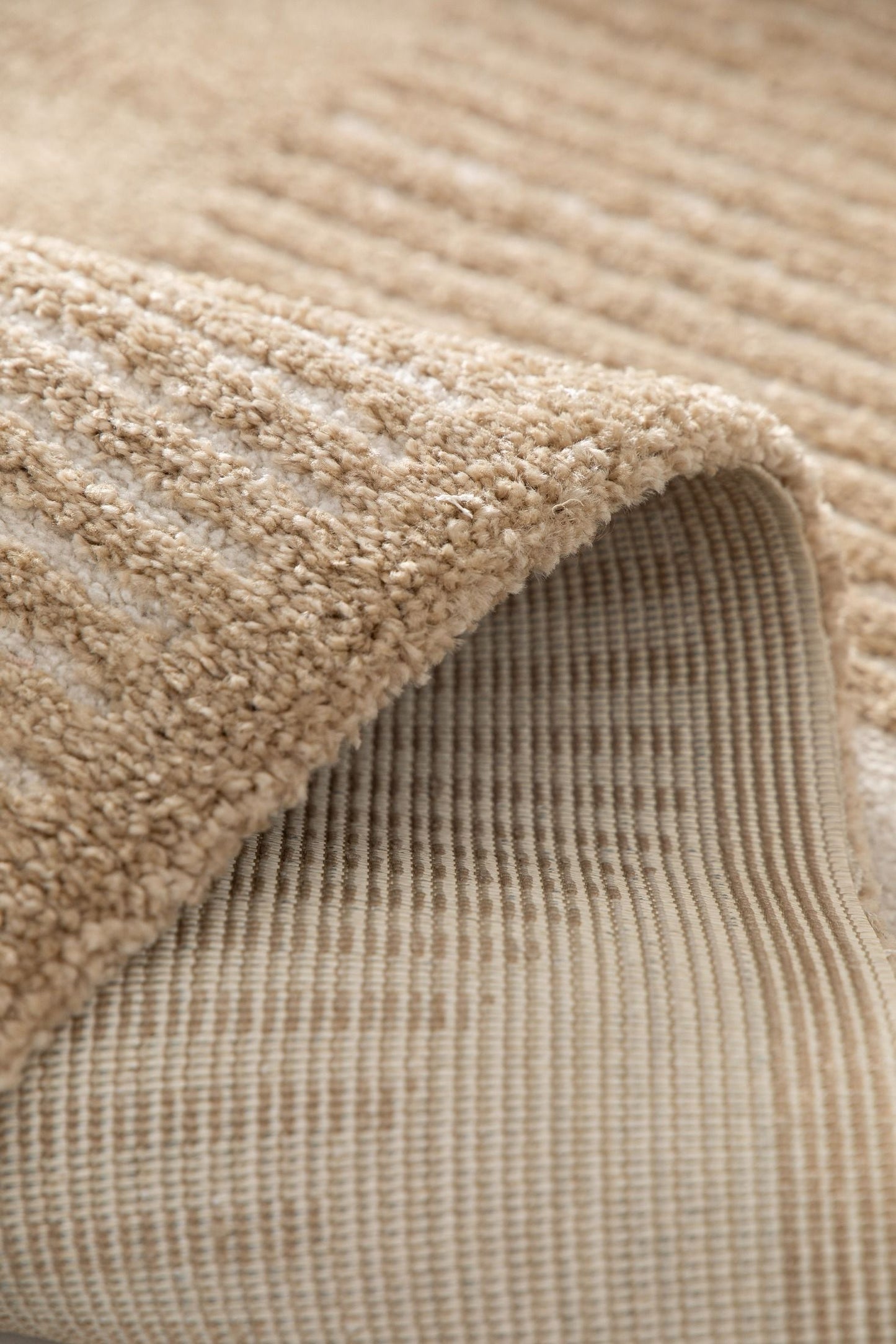 Osmond Waves Beige rug with soft geometric patterns in a neutral palette and a high-low textured finish. Colour Beige and Cream. Sizes 160 X 230, 200 X 290 and 240 X 340. Fold.