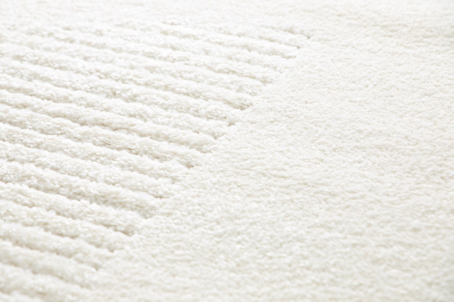 Osmond Waves Ivory rug with soft geometric patterns in a neutral palette and a high-low textured finish. Colours Ivory and Light Grey. Sizes 160 X 230, 200 X 290 and 240 X 340. Angle Close.