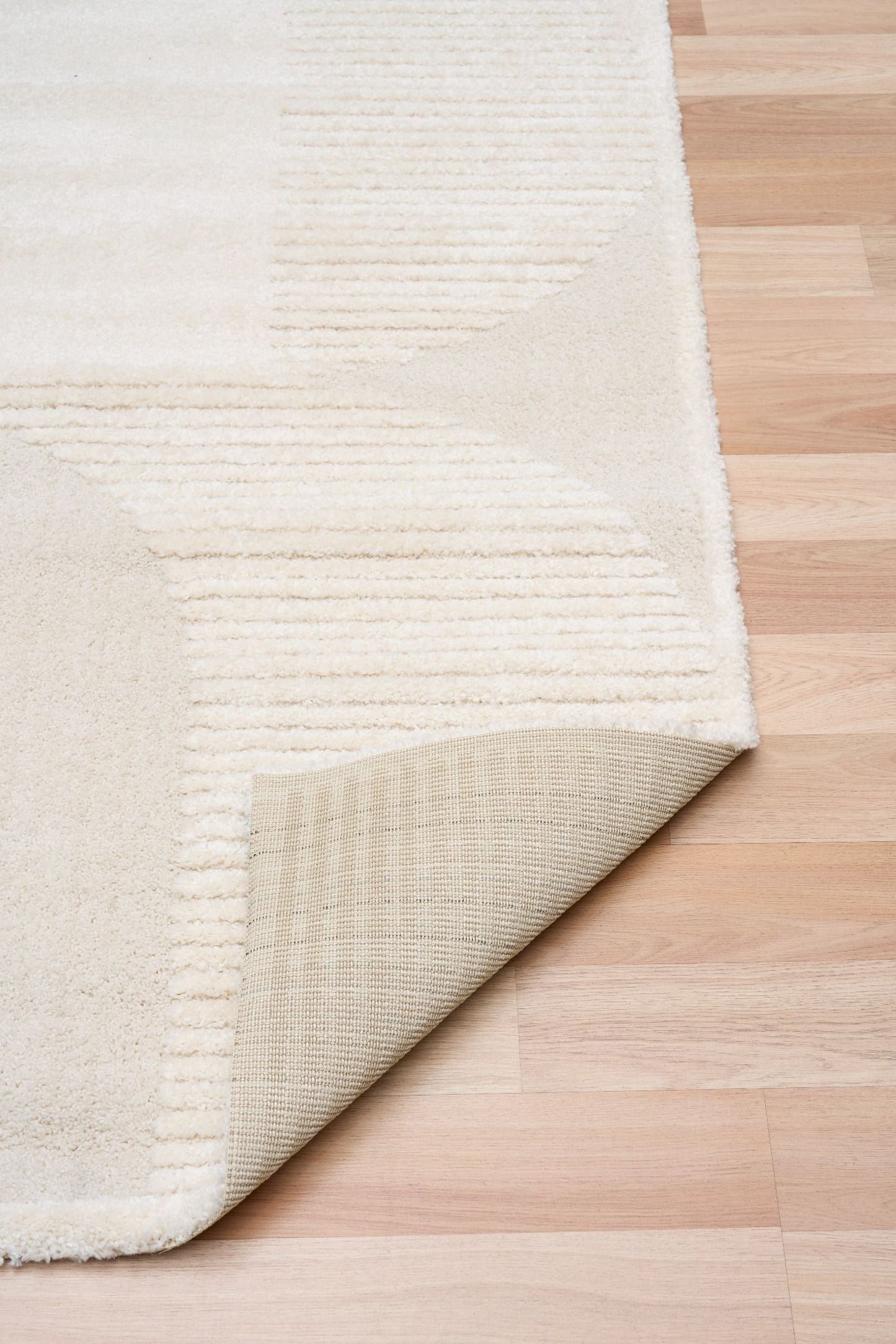 Osmond Waves Ivory rug with soft geometric patterns in a neutral palette and a high-low textured finish. Colours Ivory and Light Grey. Sizes 160 X 230, 200 X 290 and 240 X 340. Fold.