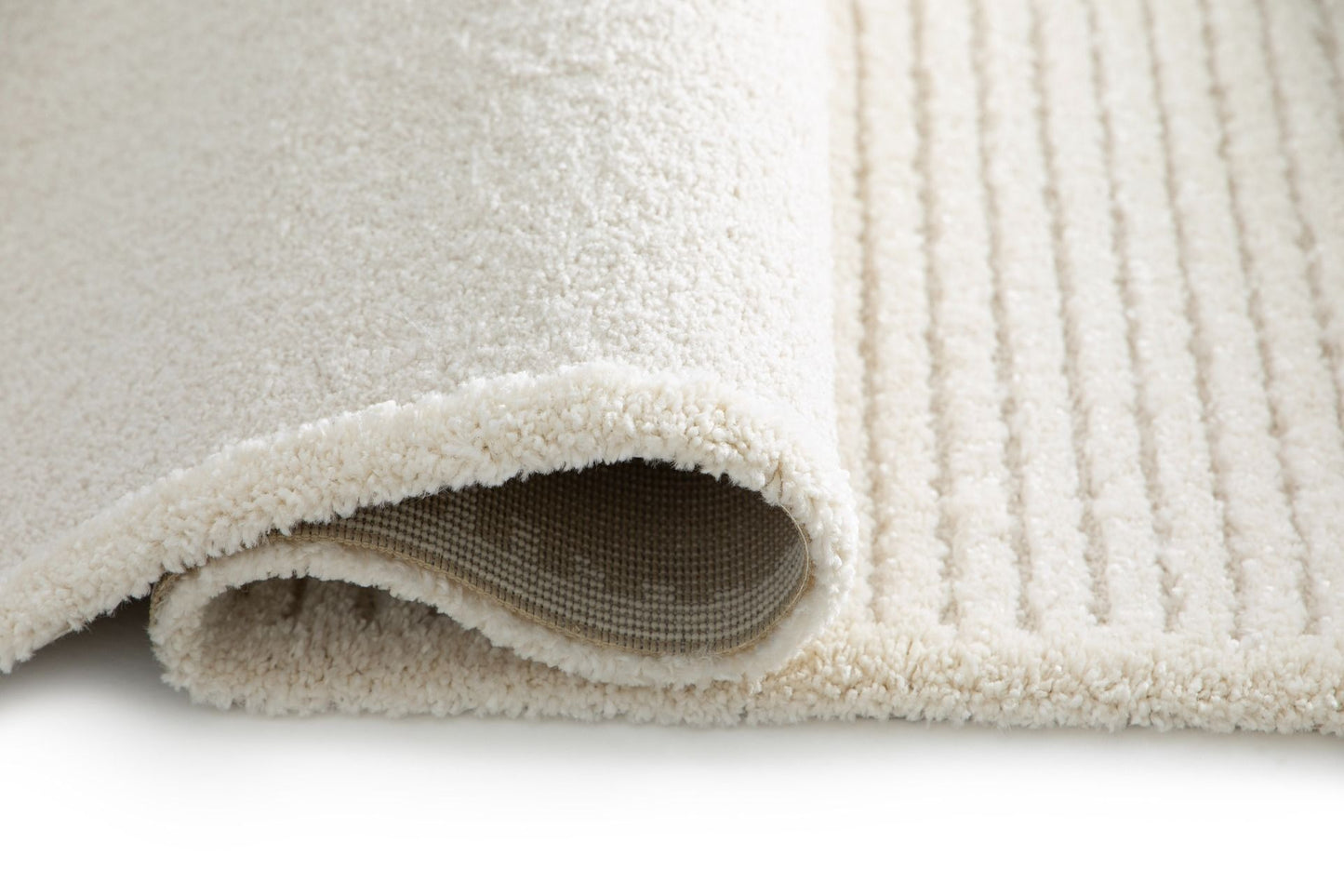 Osmond Waves Ivory rug with soft geometric patterns in a neutral palette and a high-low textured finish. Colours Ivory and Light Grey. Sizes 160 X 230, 200 X 290 and 240 X 340. Side Roll.