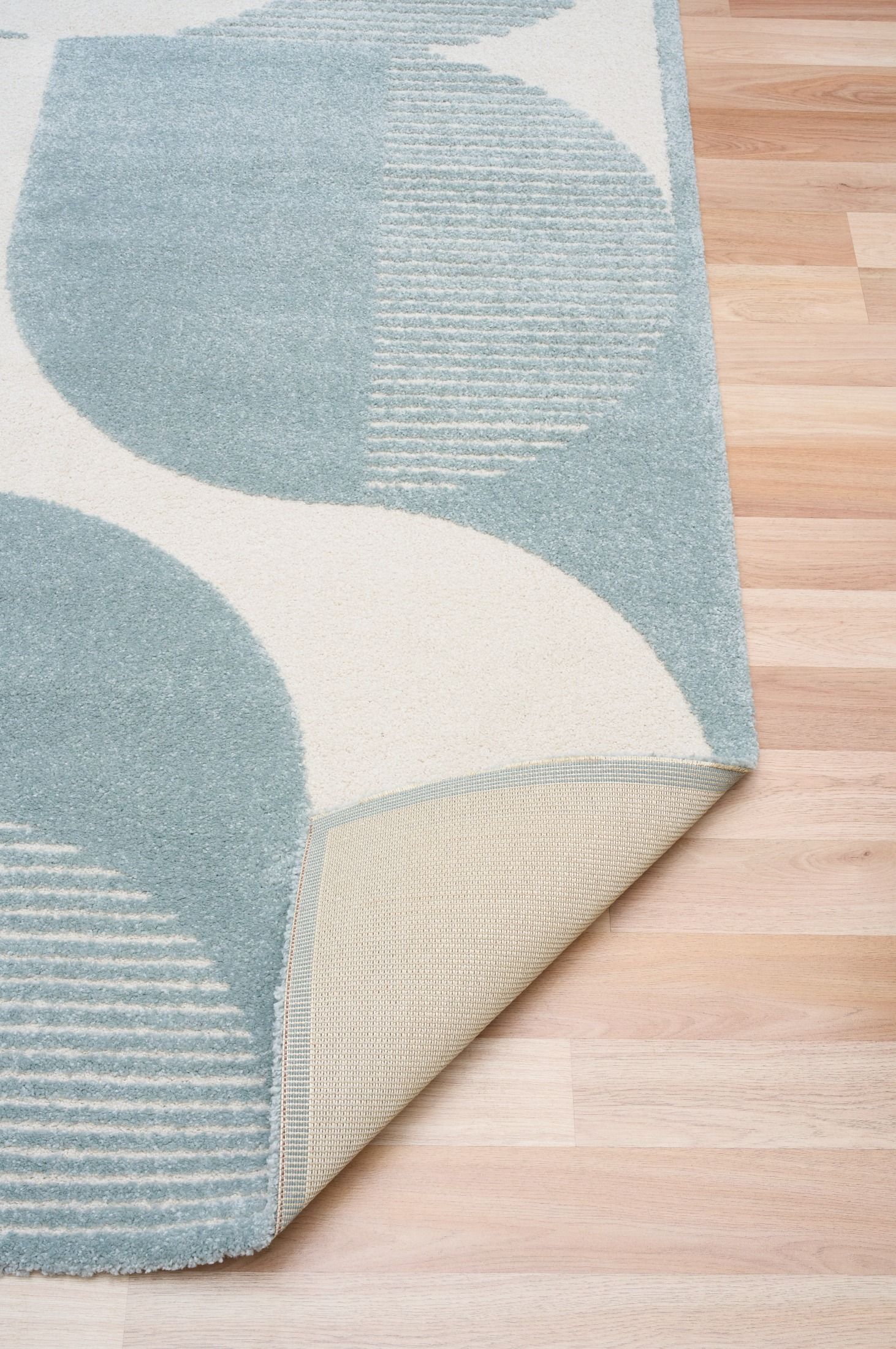 Osmond Waves Light Blue rug with soft geometric patterns in a neutral palette and a high-low textured finish. Colours Light Blue and Ivory. Sizes 160 X 230, 200 X 290 and 240 X 340. Fold.